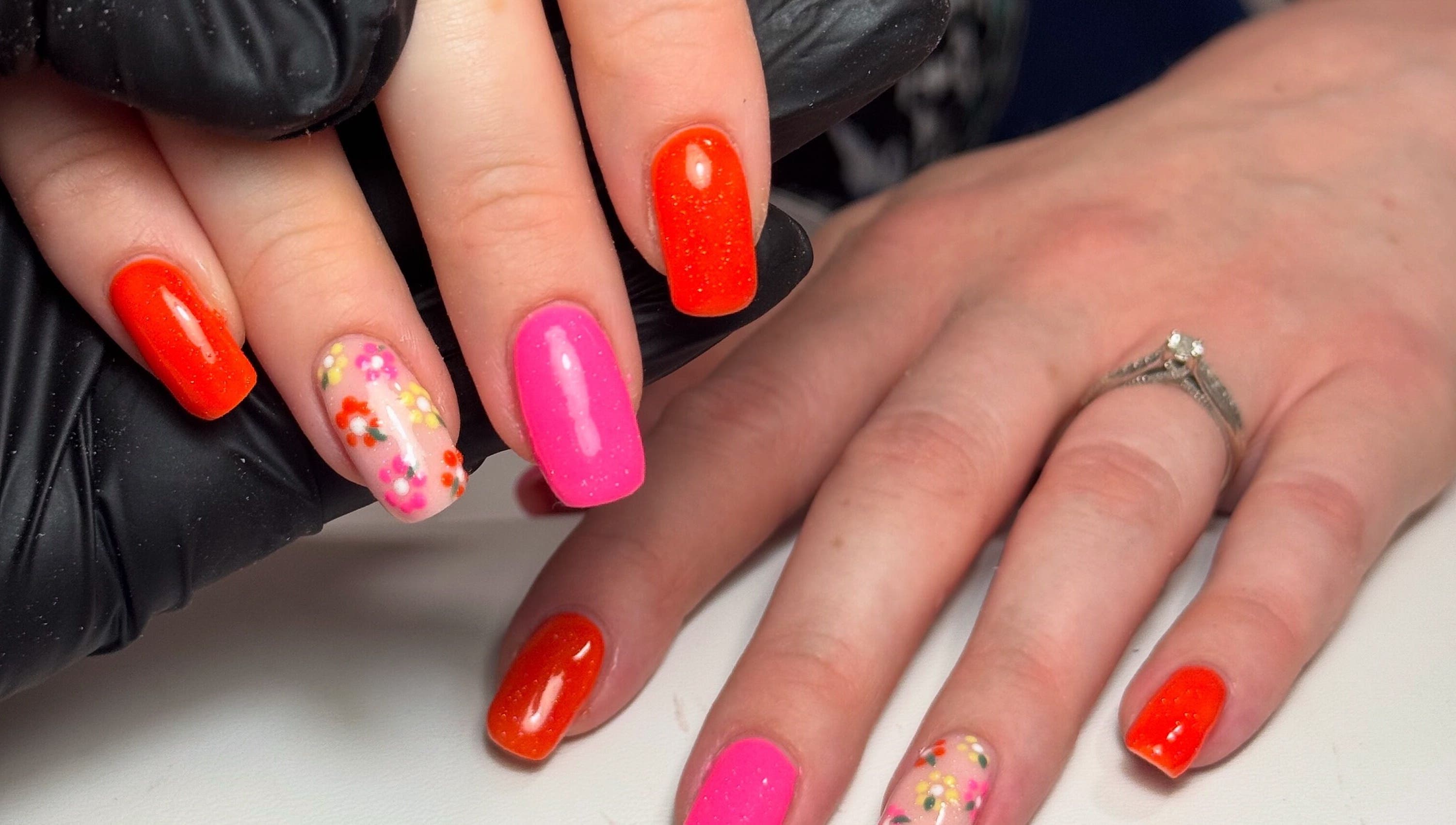 Colorful nail art with floral designs at Nails by Lulu, located in Fareham, England, GB.