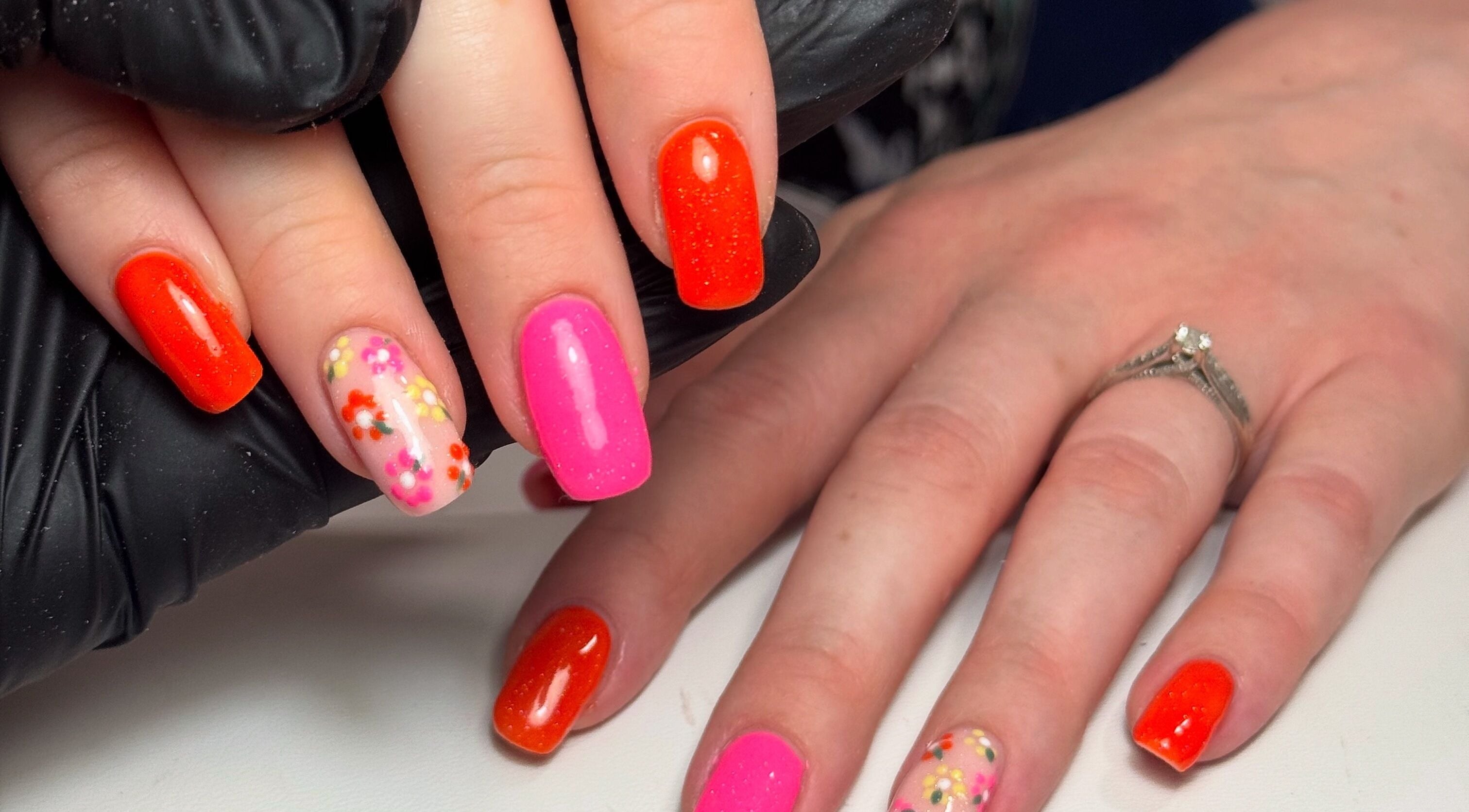 Colorful nail art with floral designs at Nails by Lulu, located in Fareham, England, GB.