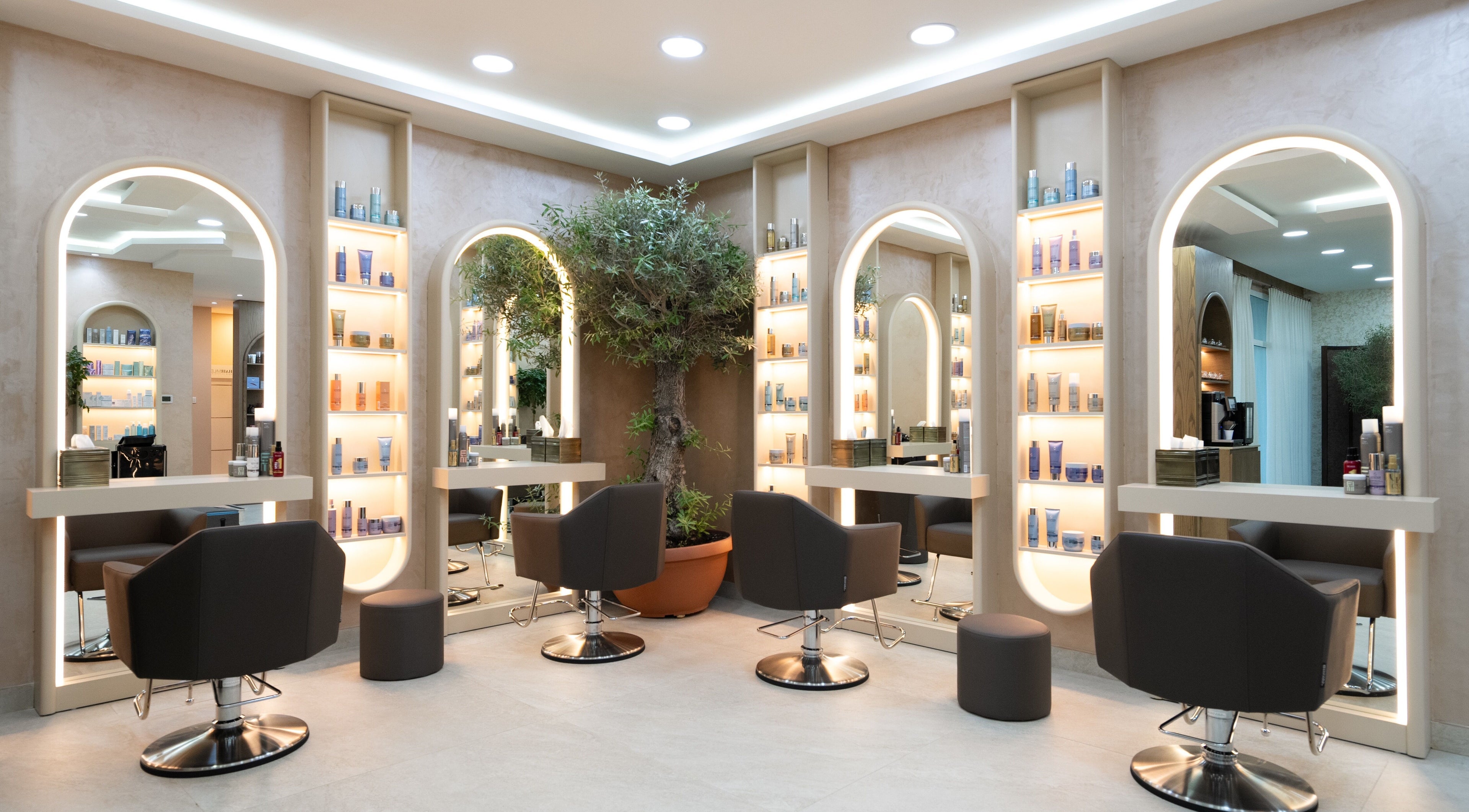 Sophisticated interior of Tess Avenue Beauty Salon, Dubai, Dubai, AE, with chic seating and illuminated mirrors.
