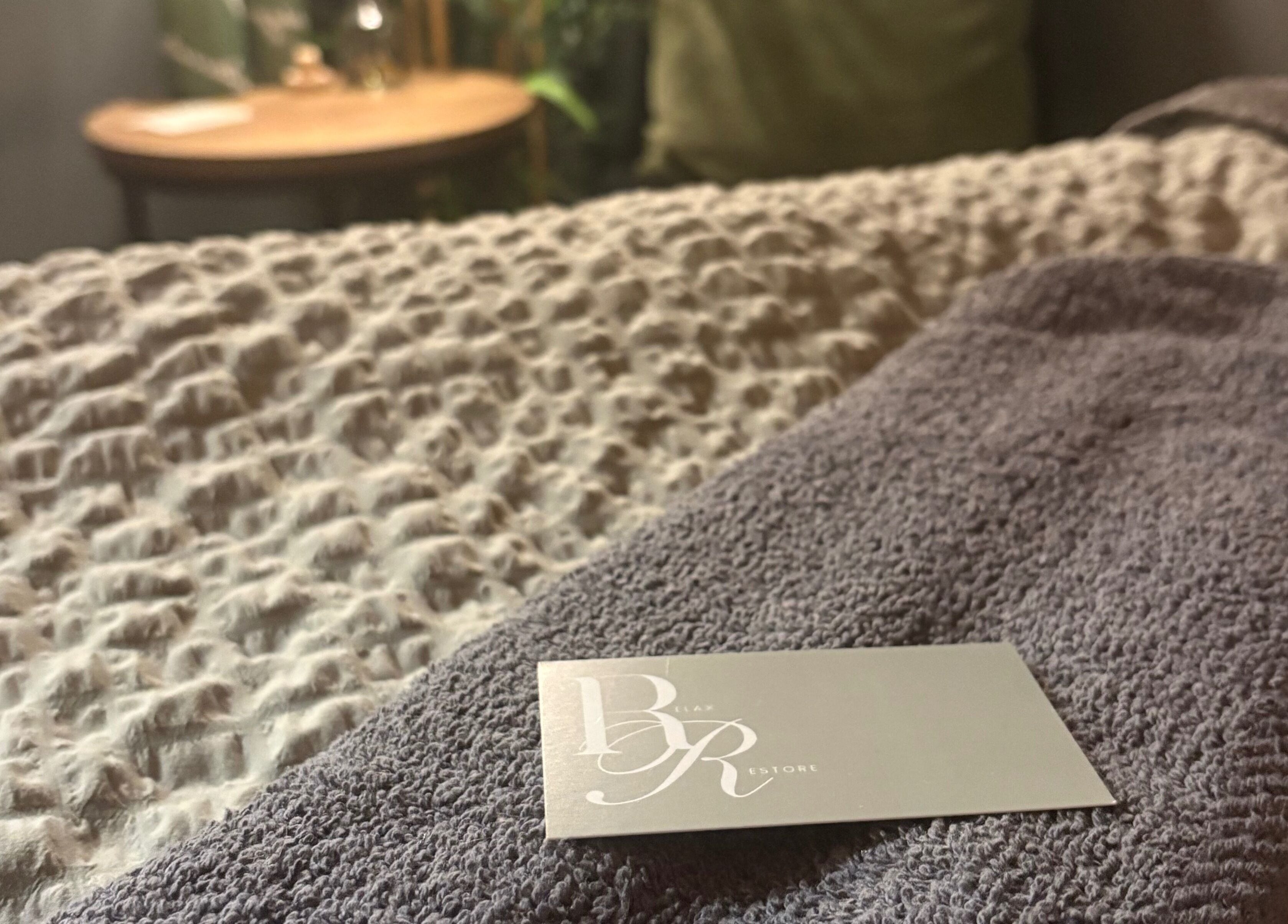 Soft towel and card at Relax & Restore Massage Therapy, Basingstoke, England, GB create a serene setting.