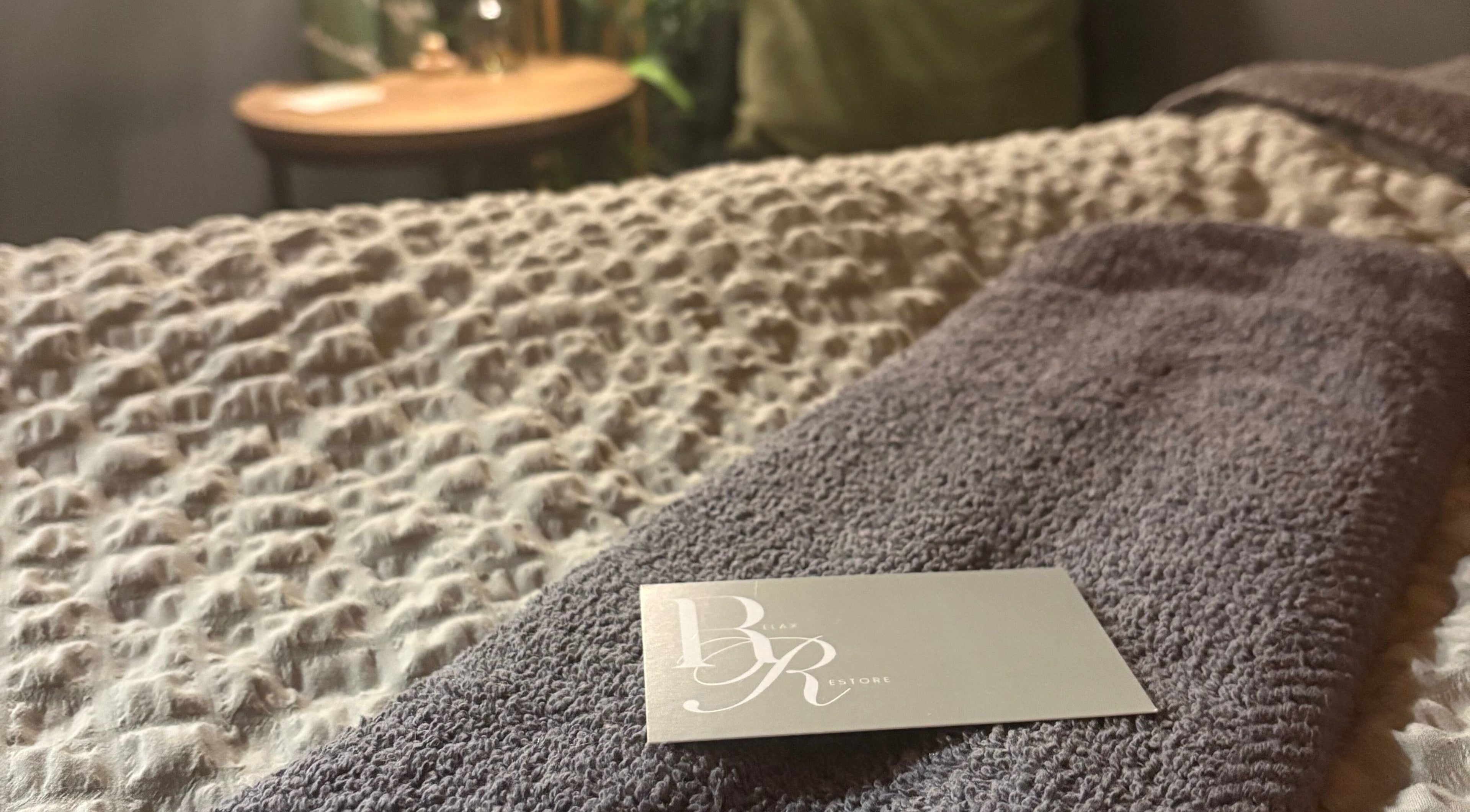 Soft towel and card at Relax & Restore Massage Therapy, Basingstoke, England, GB create a serene setting.