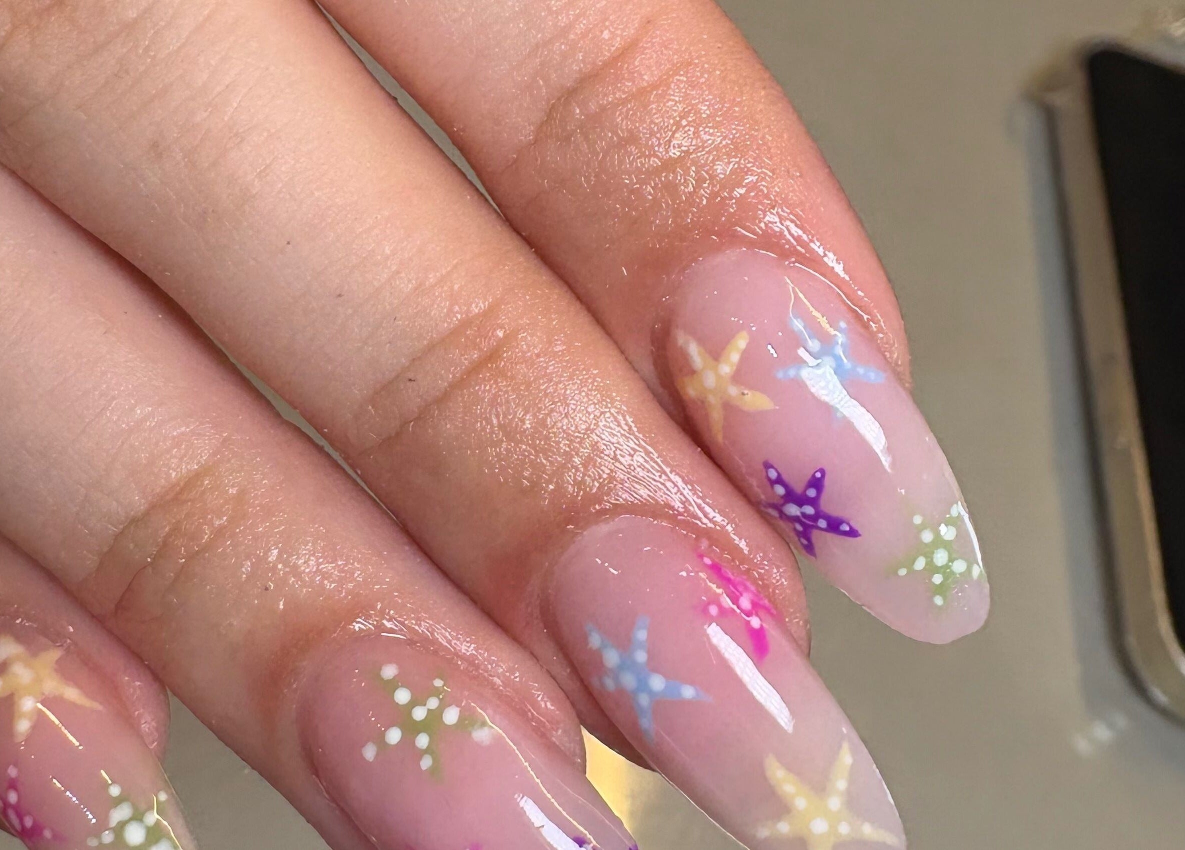 Colorful star-themed nail art by Nails by Emily Katie in Burnley, England, GB for a chic look.