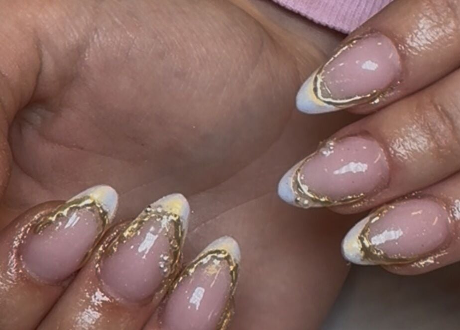 Close-up of elegant gold-trimmed nails by Nails by Emily Katie in Burnley, England, GB.