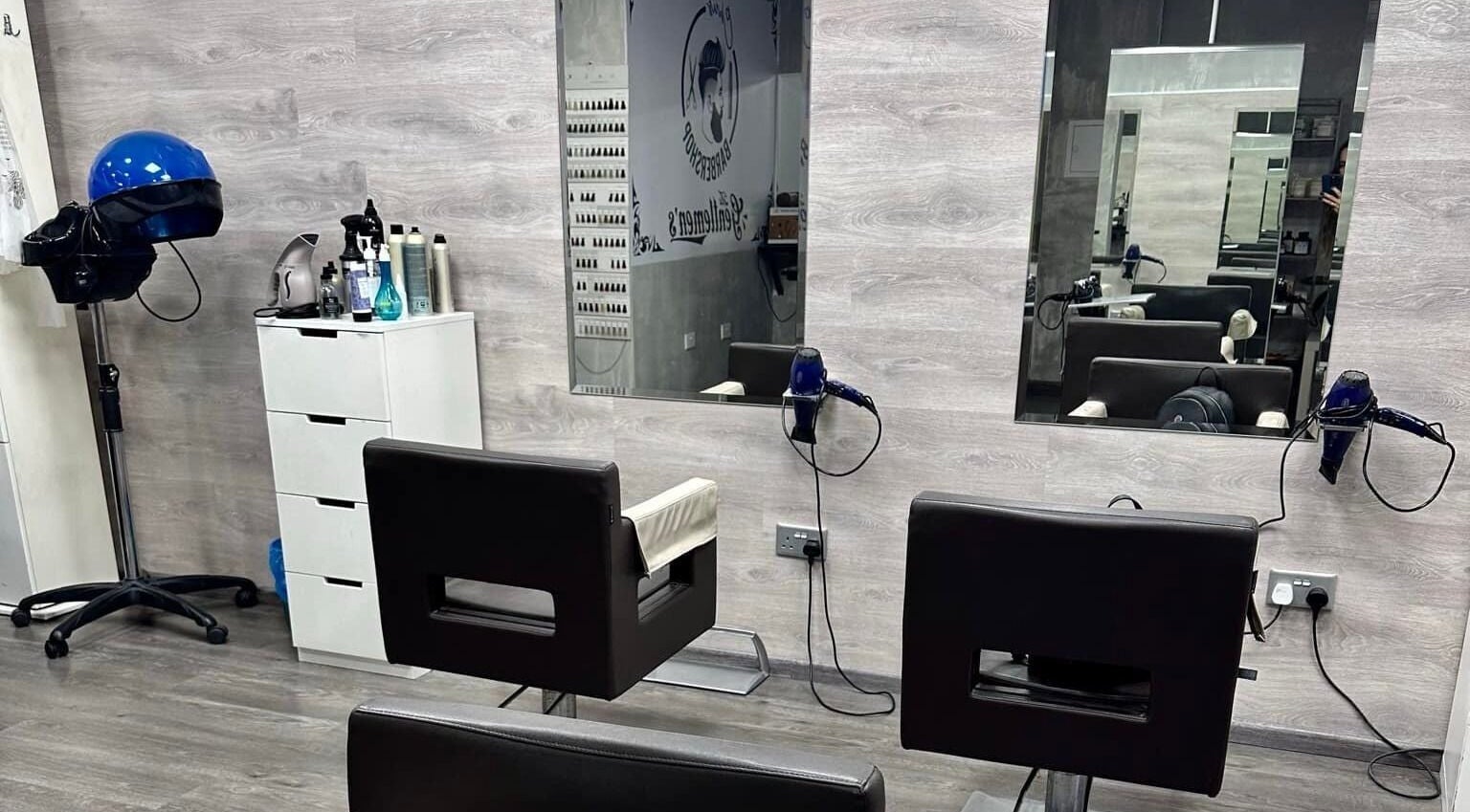 Modern interior at Chris Unisex Hair Salon, Paphos. Stylish chairs, mirrors, and hair equipment create a chic atmosphere.