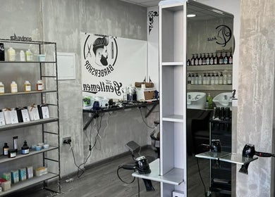Modern interior of Chris Unisex Hair Salon in Paphos, CY with hair products and styling stations.