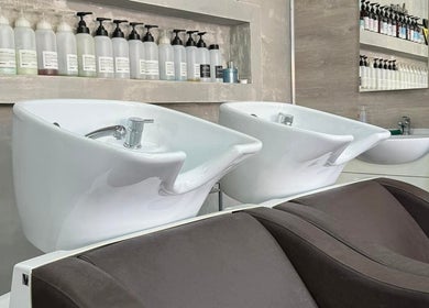 Modern washbowls at Chris Unisex Hair Salon, Paphos, CY, showcasing premium salon hair products.