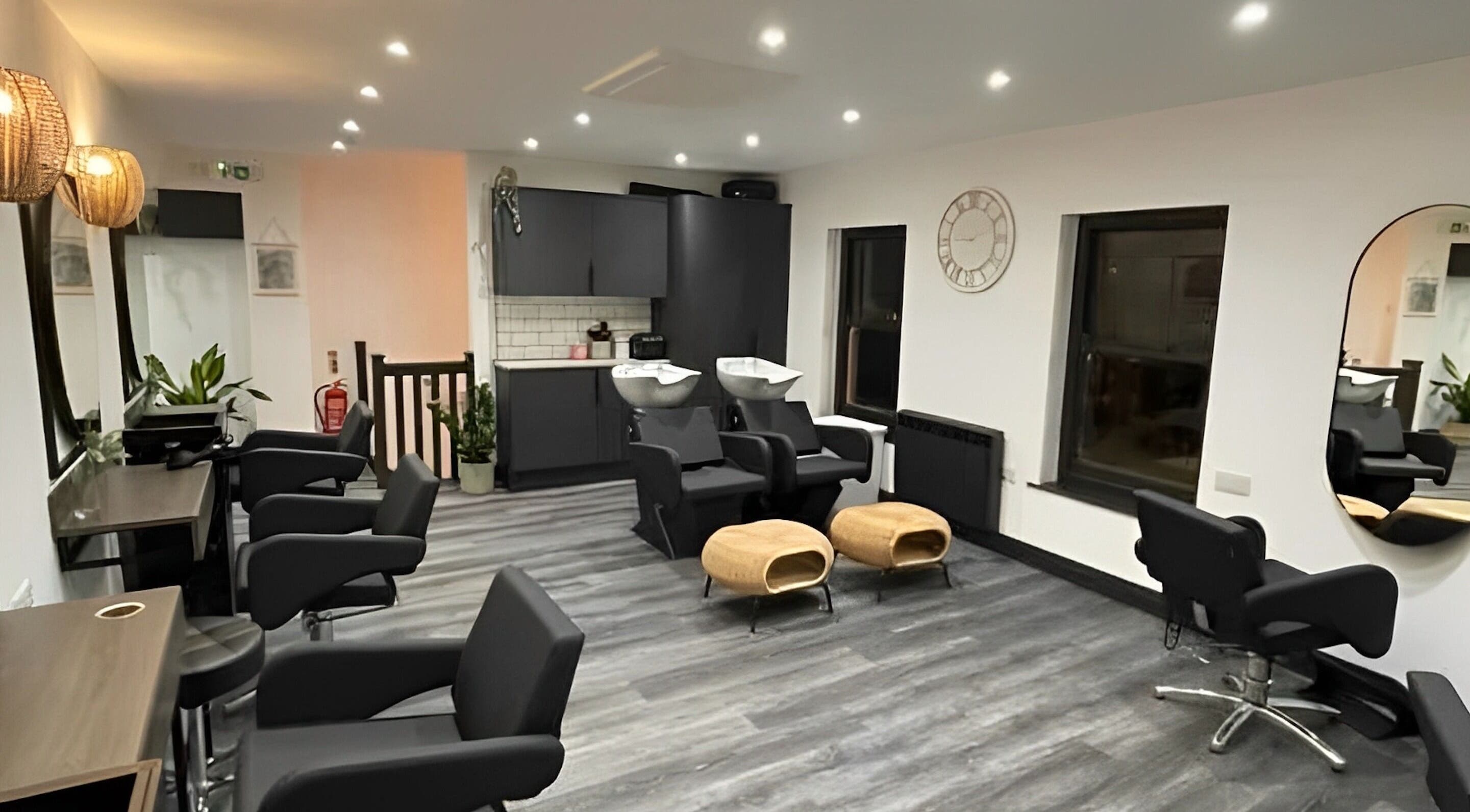 Modern salon interior at Bryony at Sage Hair Collective, Liskeard, England, GB with sleek chairs and wash stations.