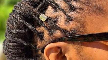 Close-up of intricate braids with a hair accessory at Stella's Spa, Gros Islet, Gros Islet, LC.