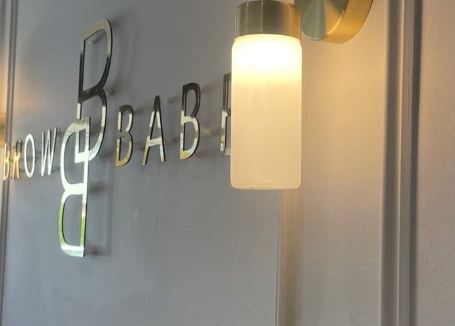 Wall lights and elegant Browbabe Welling sign in Welling, England, GB beauty venue.