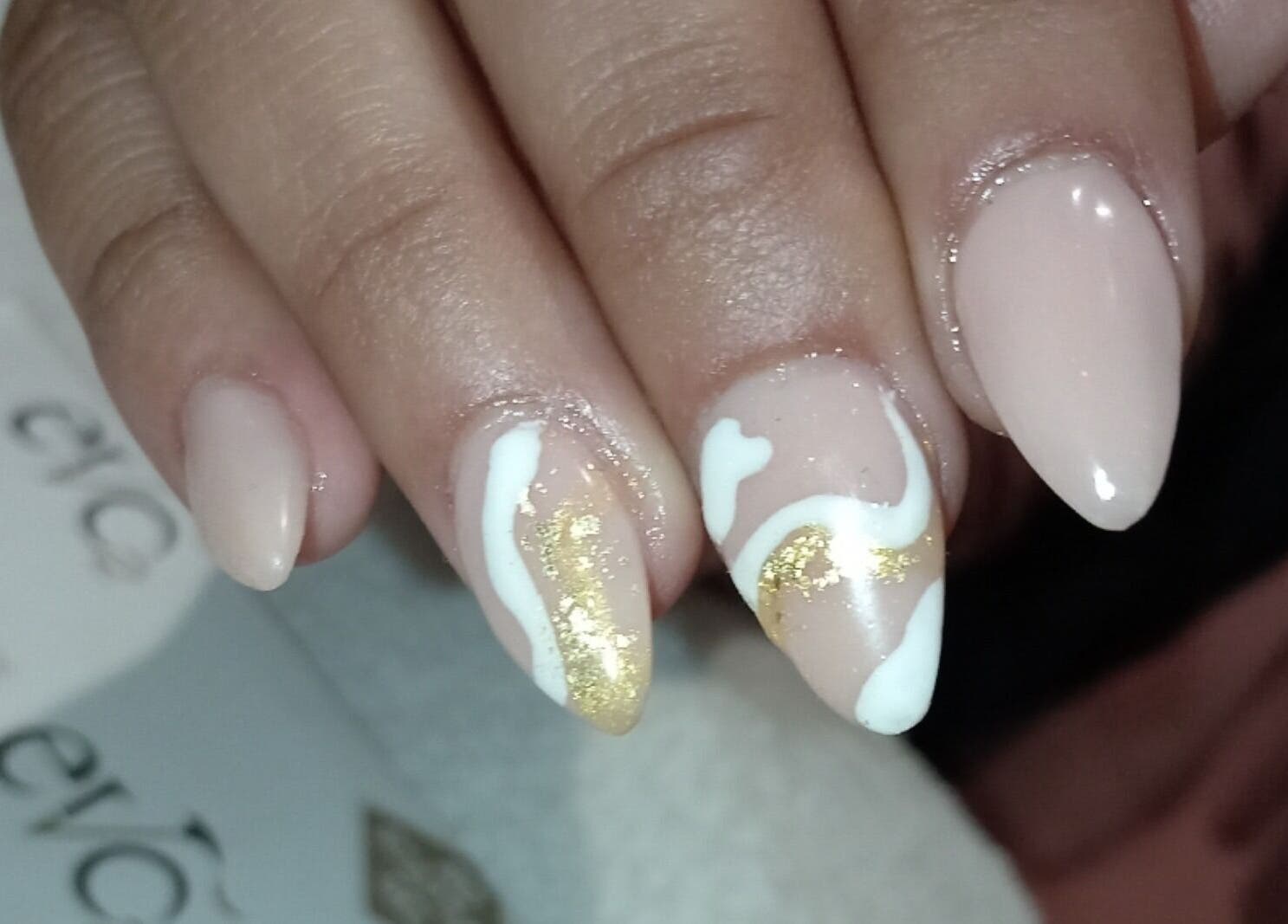 Elegant nail art with gold and white swirls at Milla Aesthetics, Randfontein, Gauteng, ZA.