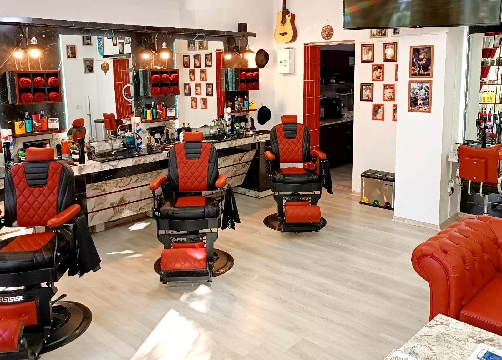 Interior modern la Vienna Style Salon din București cu scaune roșii elegante.