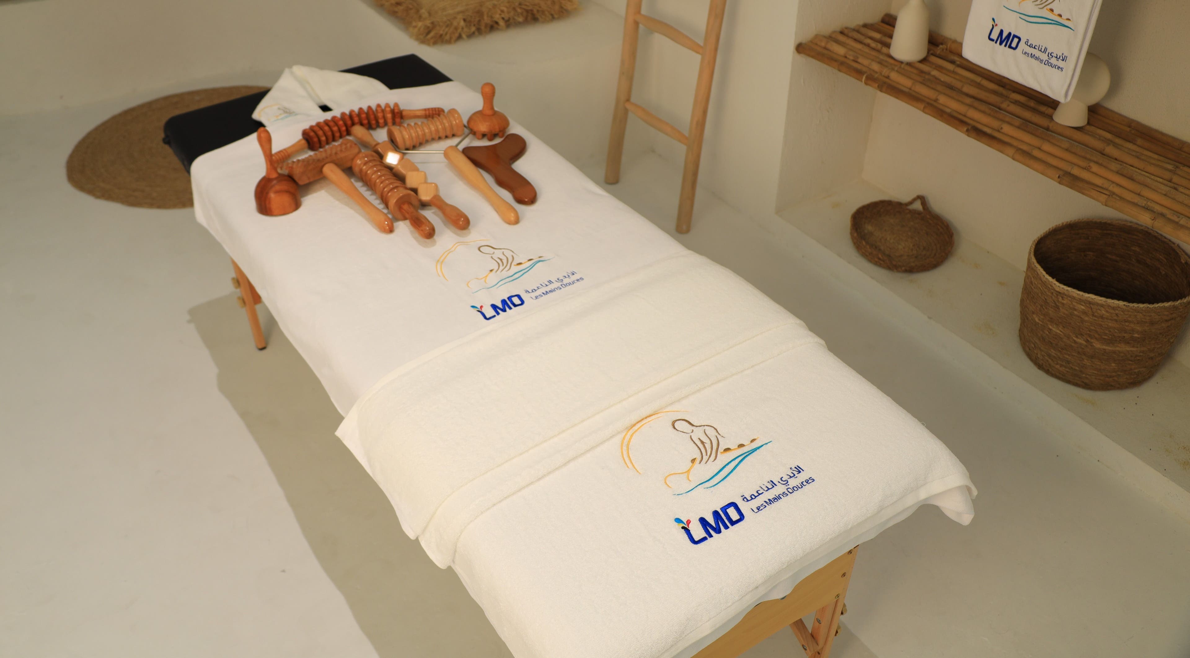 Massage table with tools at LMD Les Mains Douces, Dubai, AE offering wellness treatments.