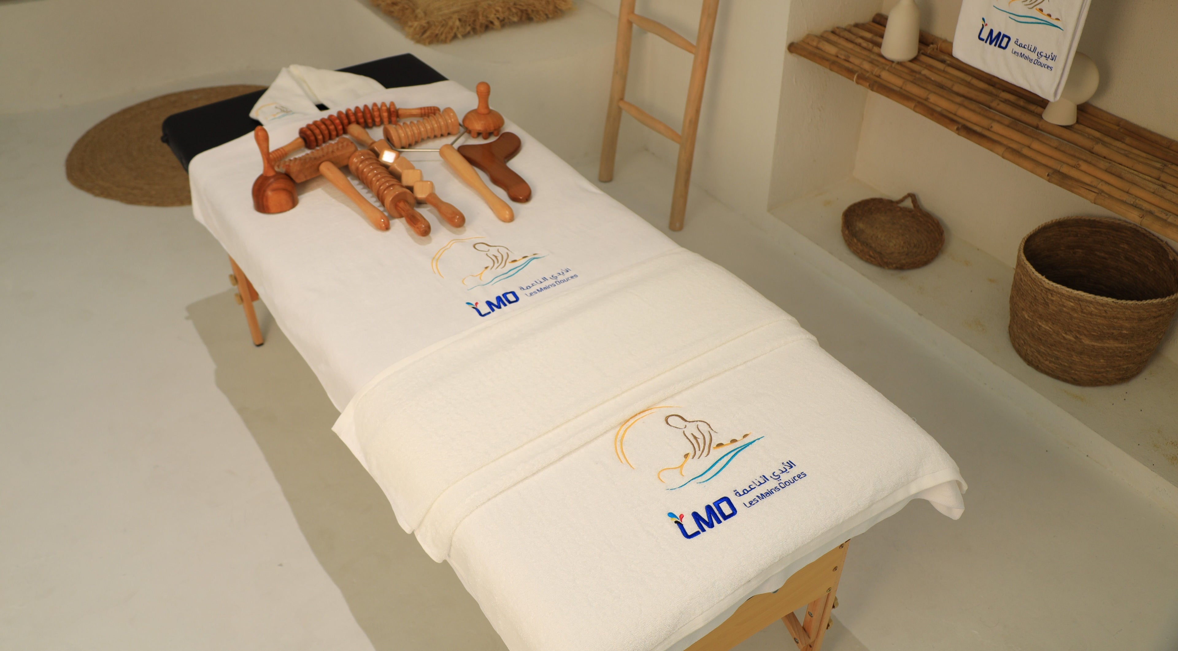 Massage table with tools at LMD Les Mains Douces, Dubai, AE offering wellness treatments.