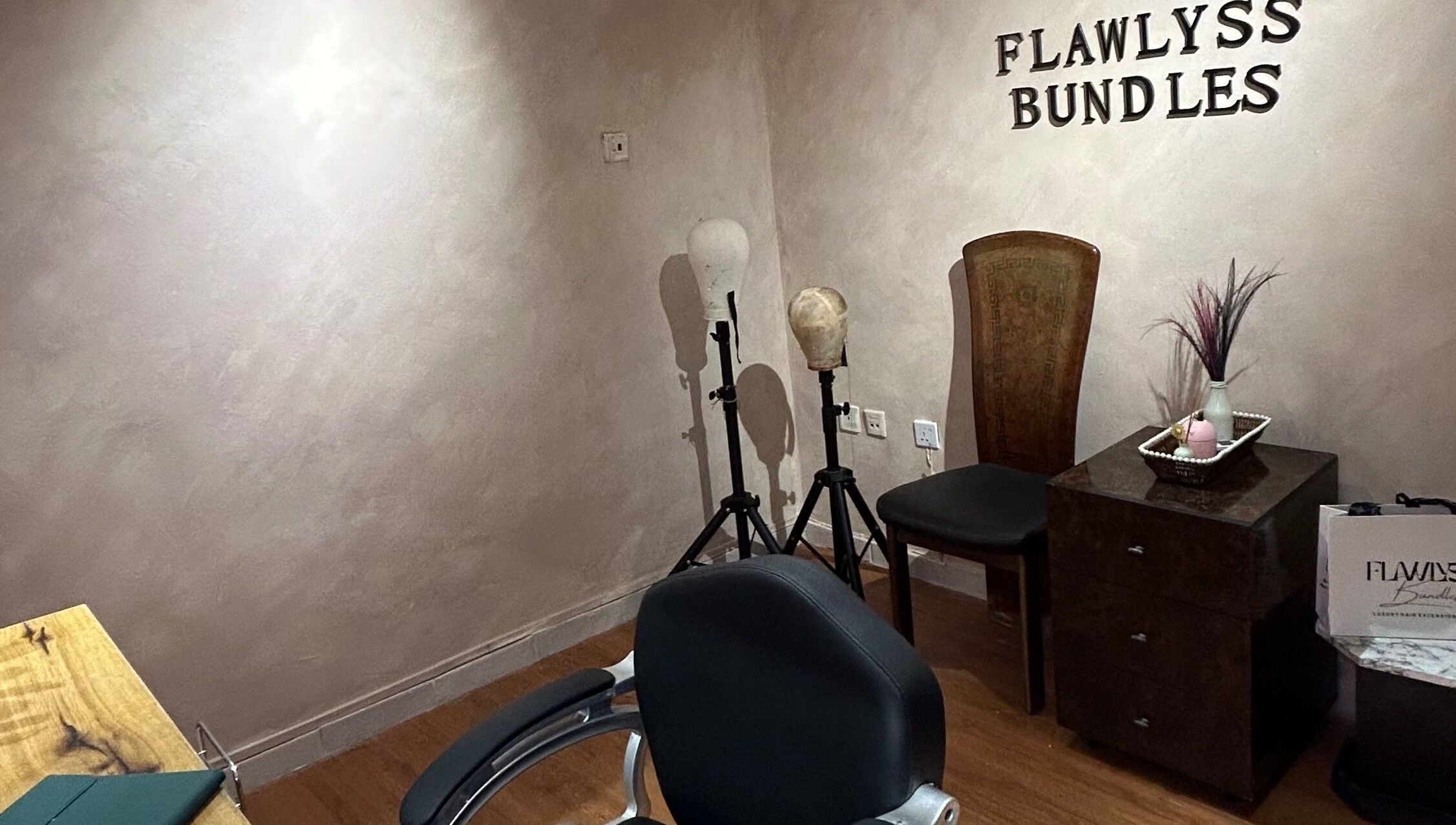 Elegant interior at Flawlyss Bundles, Lagos. Features styling heads and decor in a serene setting.