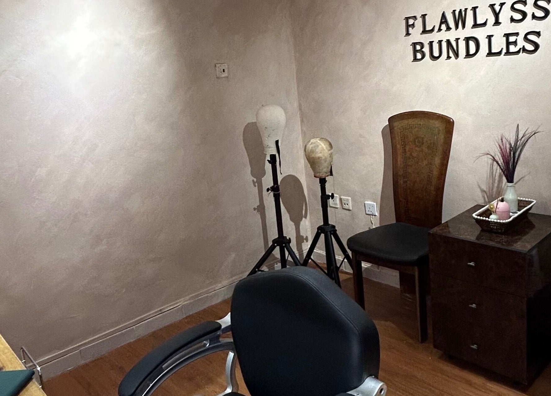 Elegant interior at Flawlyss Bundles, Lagos. Features styling heads and decor in a serene setting.
