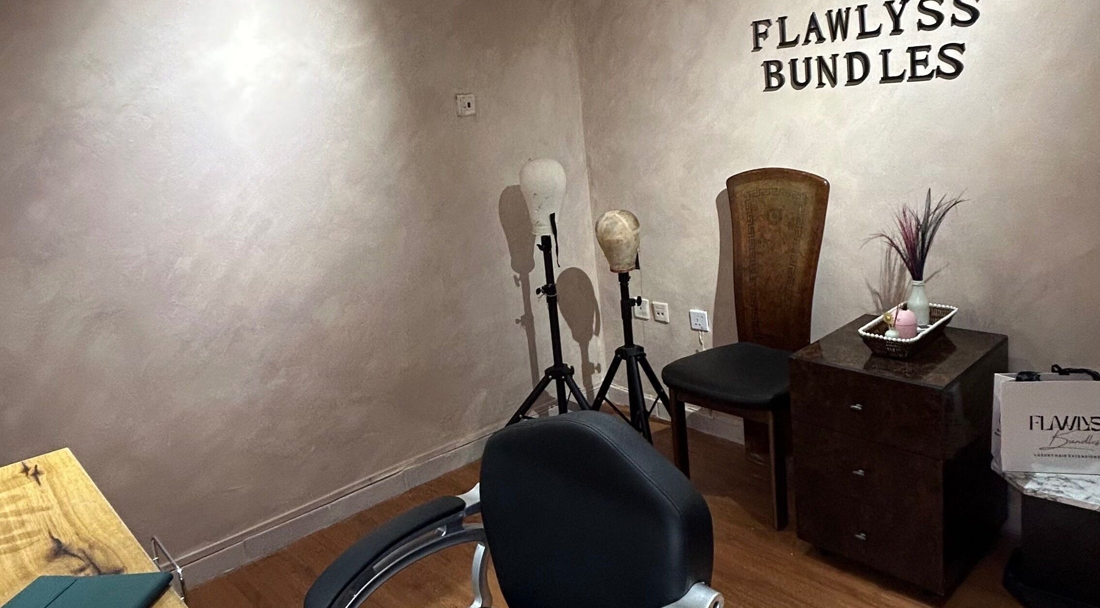 Elegant interior at Flawlyss Bundles, Lagos. Features styling heads and decor in a serene setting.