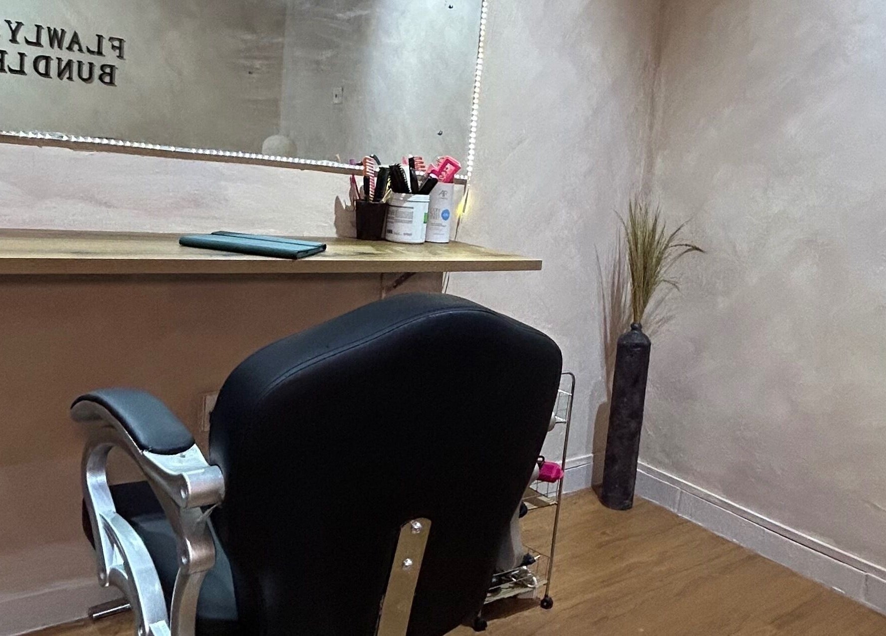 Flawlyss Bundles salon chair and styling station in Lagos, Lagos, NG offers a sleek, modern beauty experience.