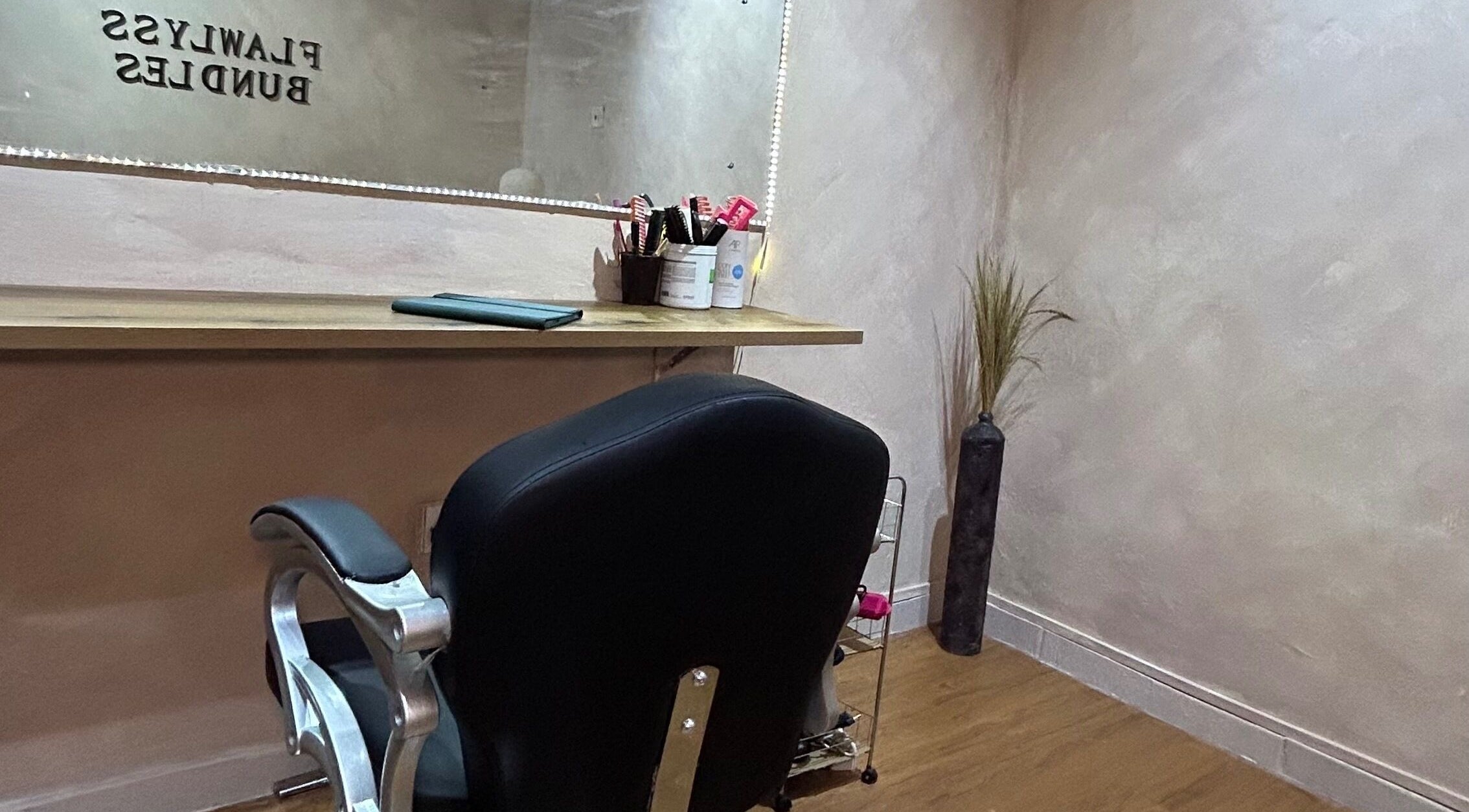 Flawlyss Bundles salon chair and styling station in Lagos, Lagos, NG offers a sleek, modern beauty experience.
