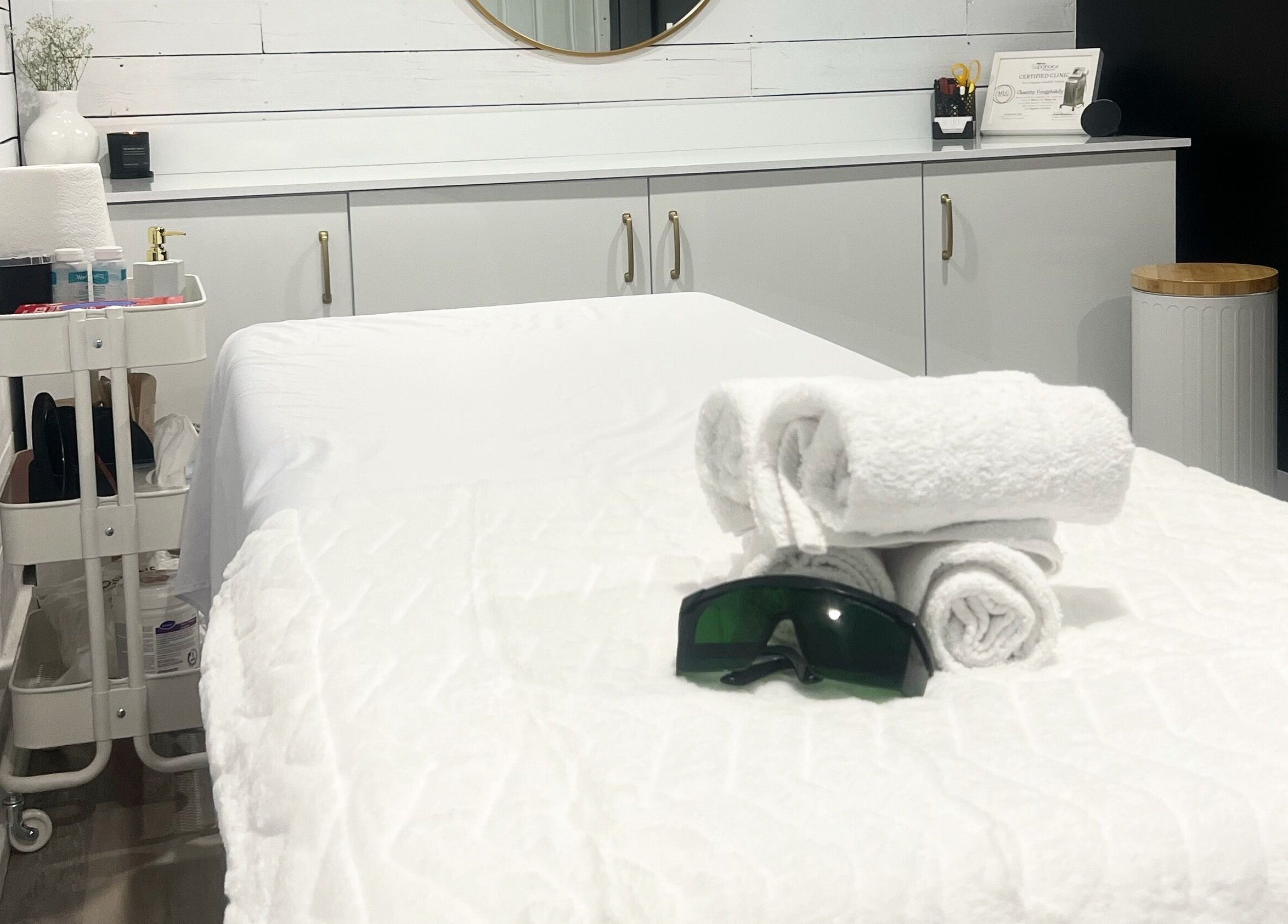 Spa treatment room at Bare Cabin, Port Colborne, Ontario, CA with neatly folded towels and soothing decor.