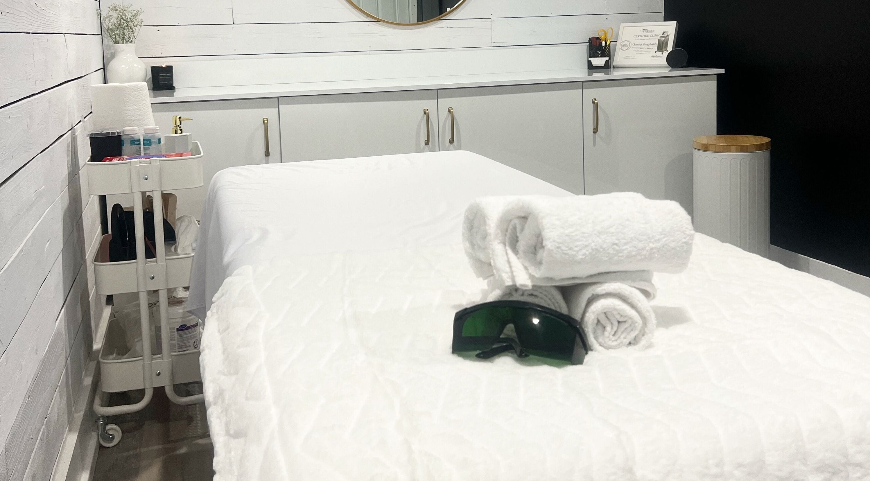 Spa treatment room at Bare Cabin, Port Colborne, Ontario, CA with neatly folded towels and soothing decor.