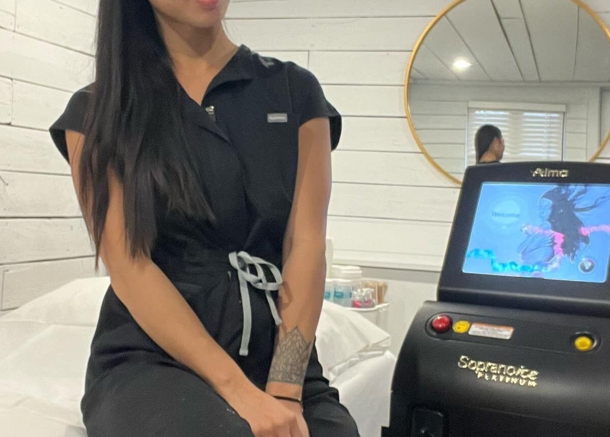 Bare Cabin spa room in Port Colborne, Ontario with a therapist beside a treatment machine.