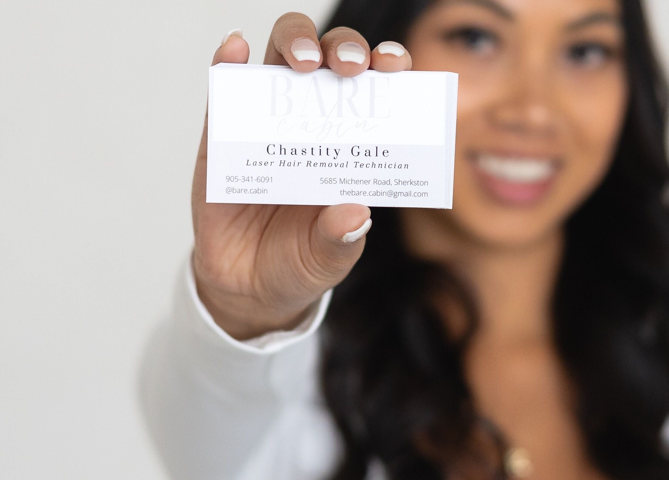 Bare Cabin business card held by person in Port Colborne, Ontario, CA.