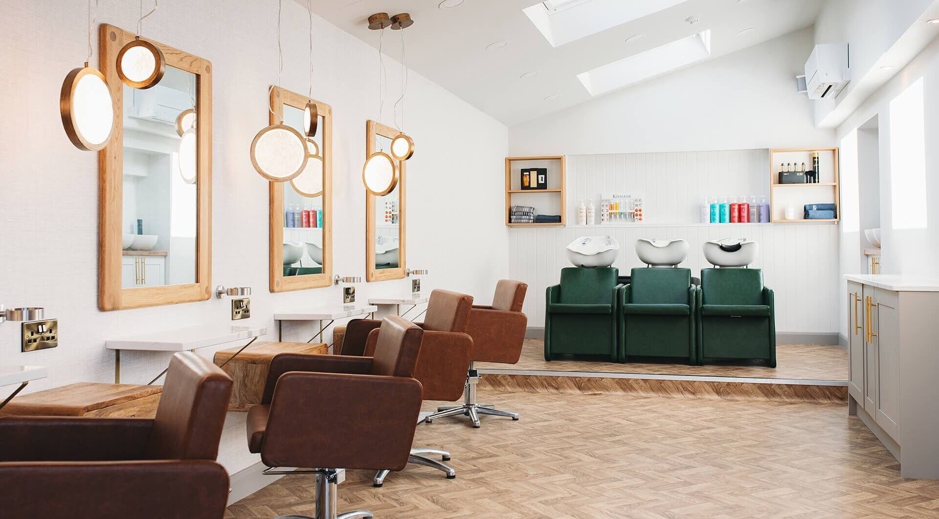 Modern interior of Megan A Ellis Hair in Cottam, England, GB with stylish salon chairs and mirrors.