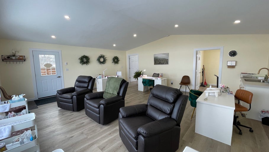 Cozy interior of Water’s Edge Aesthetics in Saint John, New Brunswick, CA, featuring reclining chairs and serene decor.