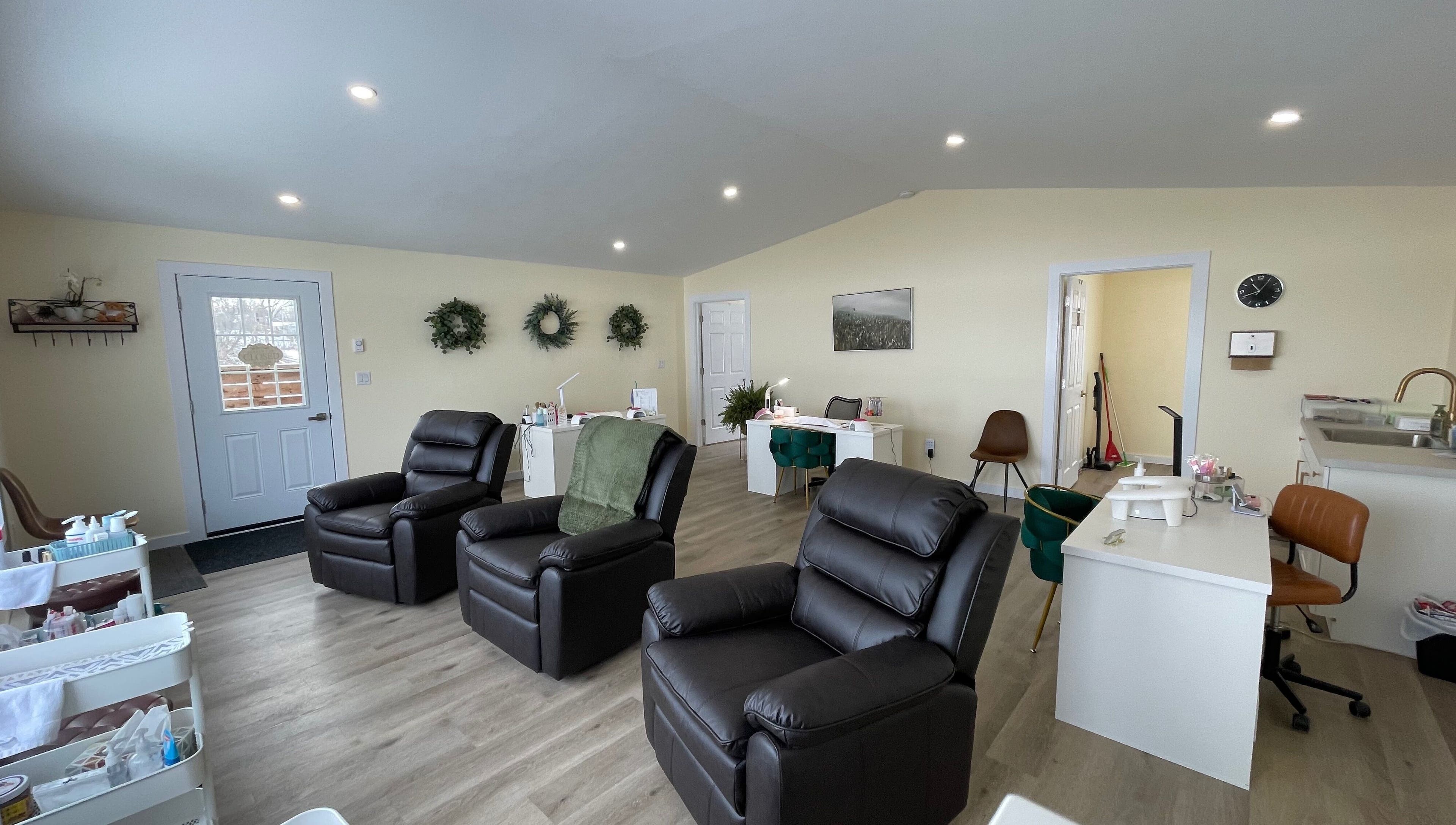 Cozy interior of Water’s Edge Aesthetics in Saint John, New Brunswick, CA, featuring reclining chairs and serene decor.