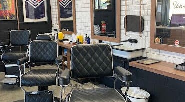Stylish interior of Uncle Joes Barber - Fremantle, featuring modern barber chairs in Fremantle, Western Australia, AU.