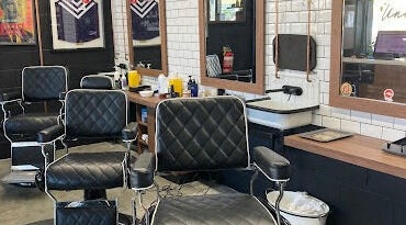Stylish interior of Uncle Joes Barber - Fremantle, featuring modern barber chairs in Fremantle, Western Australia, AU.