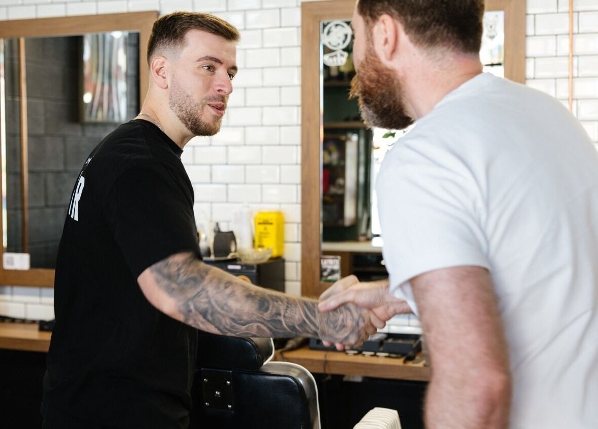 Barber greeting client at Uncle Joes Barber - Fremantle, Western Australia, AU.