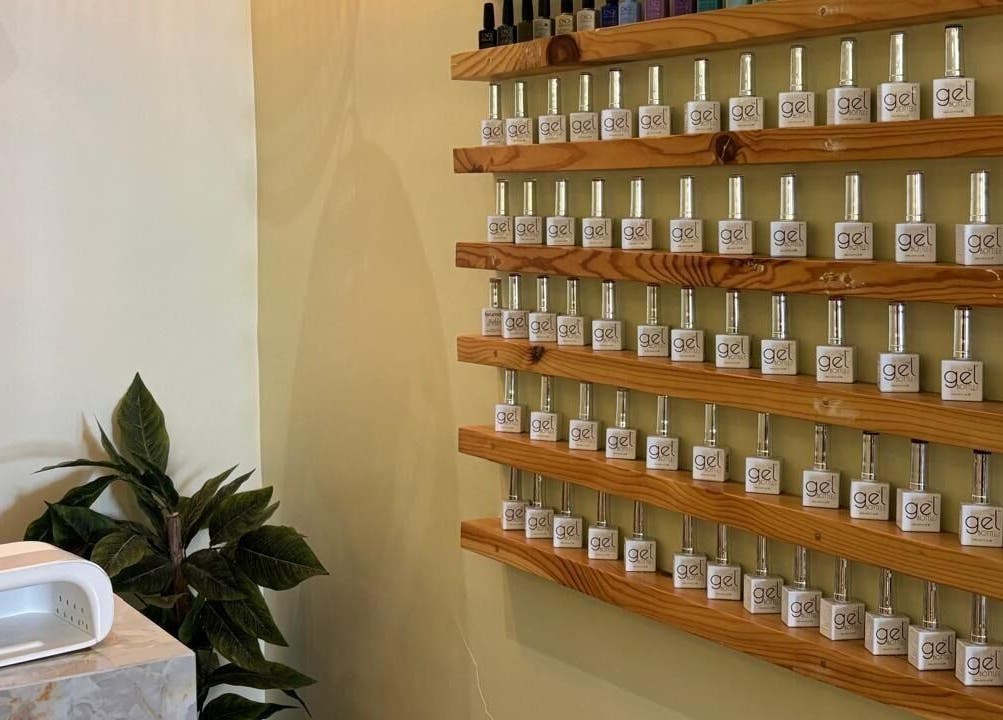 Nail polish bottles on wooden shelves at Brillante Spa, Riyadh, Riyadh Province, SA for a stylish touch.