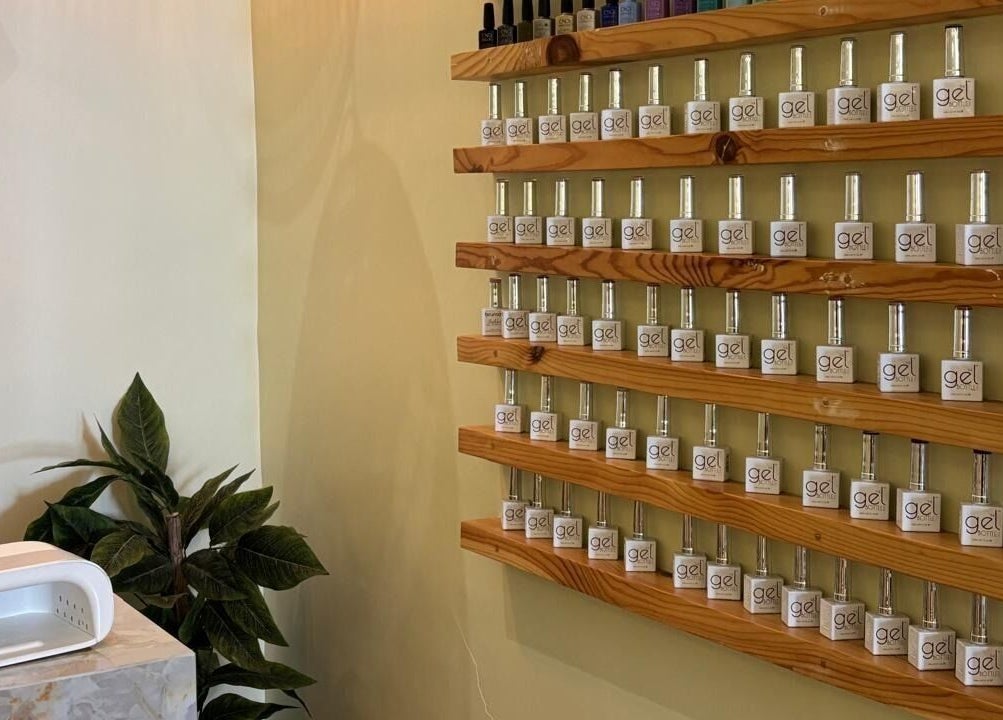 Nail polish bottles on wooden shelves at Brillante Spa, Riyadh, Riyadh Province, SA for a stylish touch.
