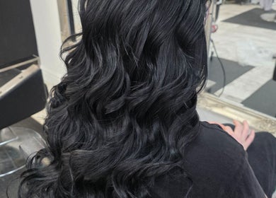 Luxurious black curls styled at Flawless, Wigan, England, GB.
