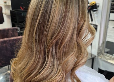 Blonde wavy hair styled at Flawless, Wigan, England, GB, highlighting salon's expertise.