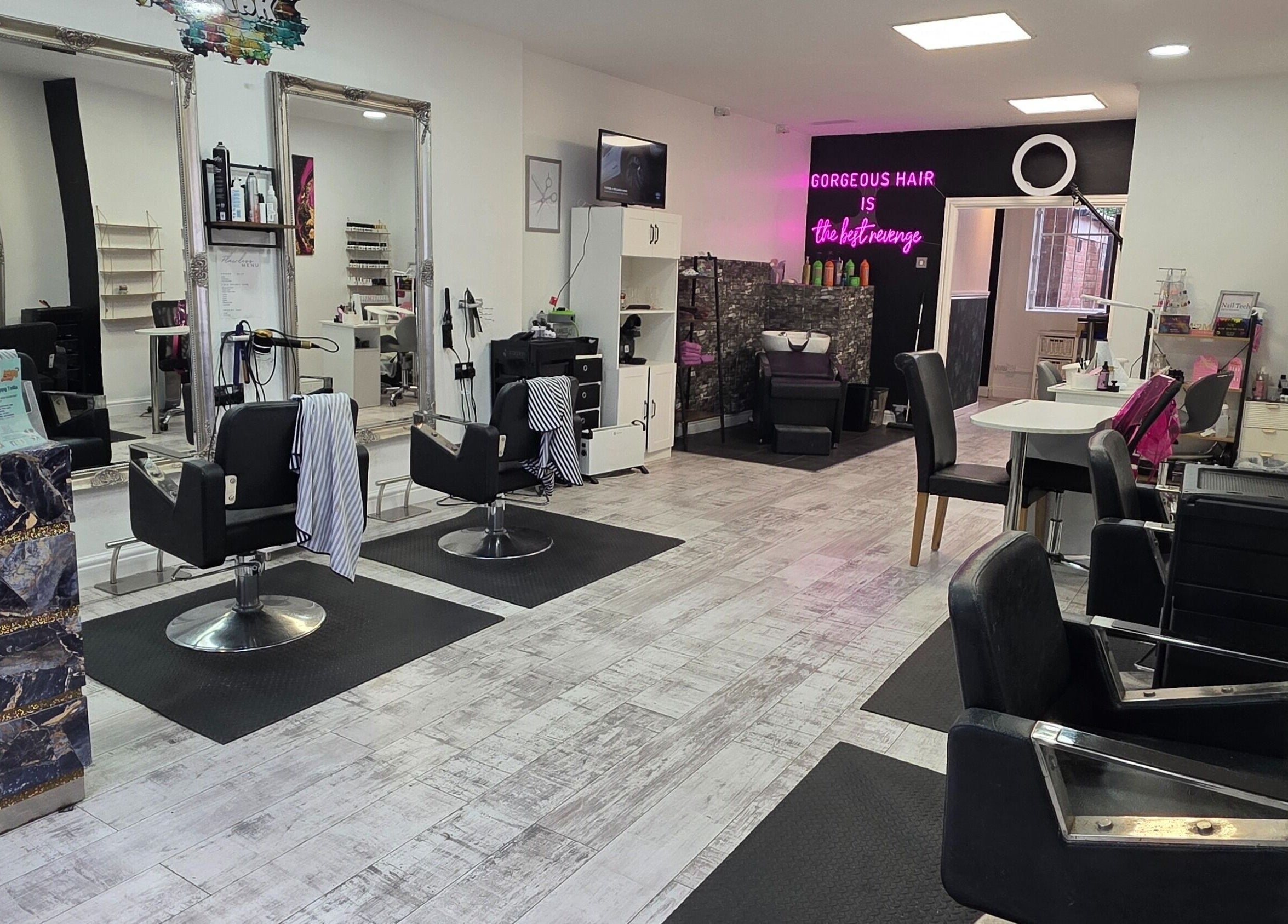Spacious and stylish beauty salon interior at Flawless in Wigan, England, GB, showcasing modern design.