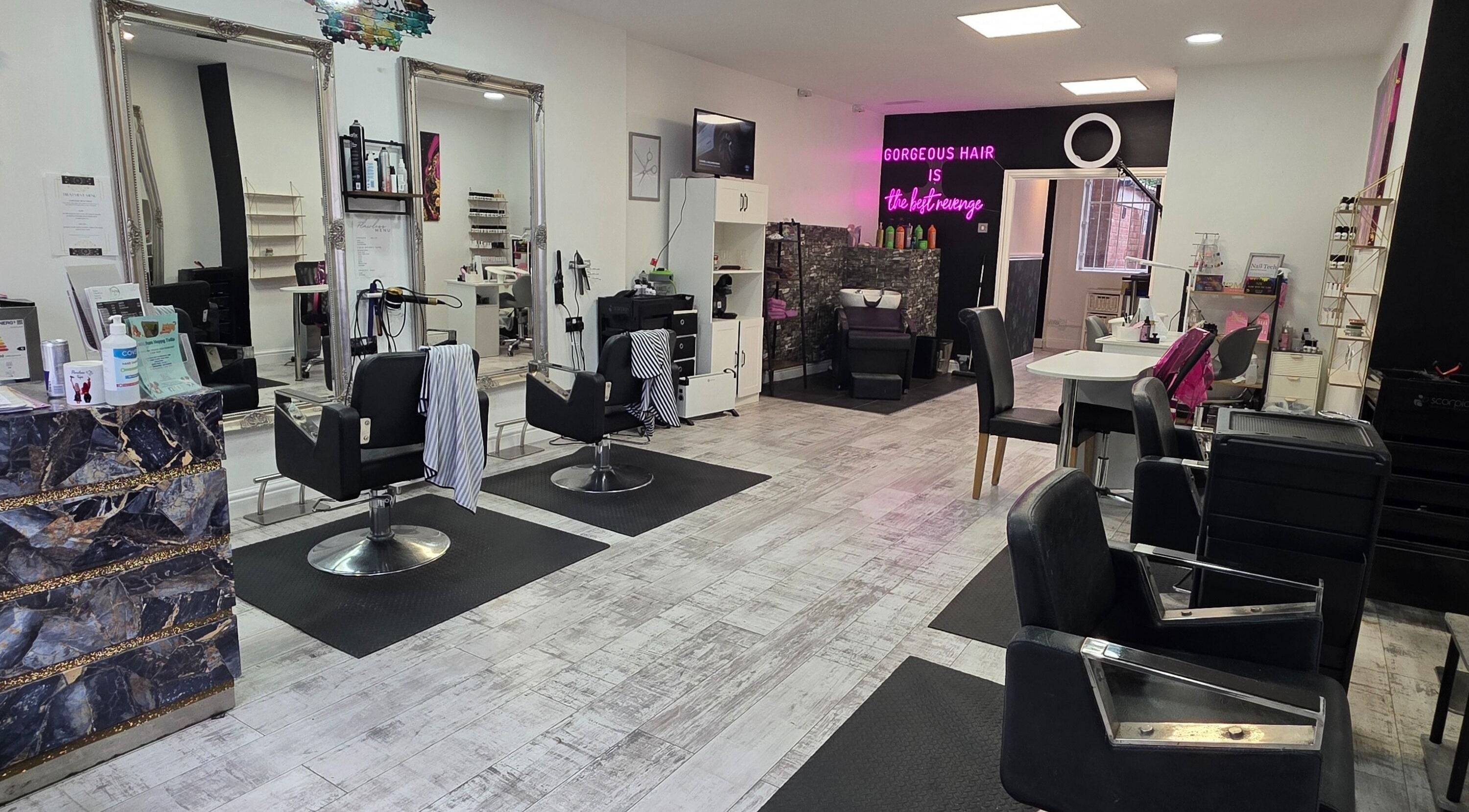 Spacious and stylish beauty salon interior at Flawless in Wigan, England, GB, showcasing modern design.