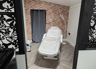 Tranquil treatment room at Flawless in Wigan, England with a comfortable chair and stylish décor.