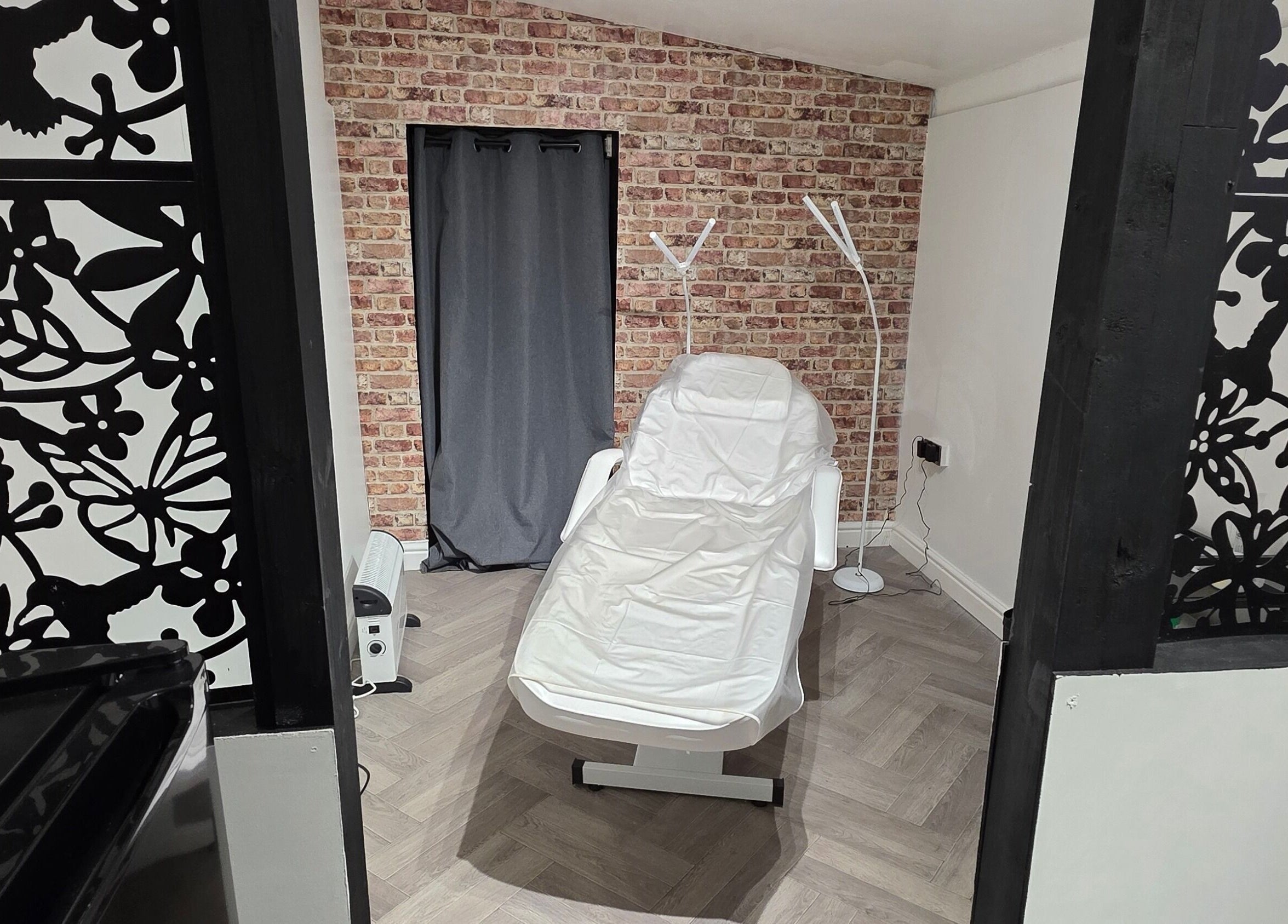 Tranquil treatment room at Flawless in Wigan, England with a comfortable chair and stylish décor.