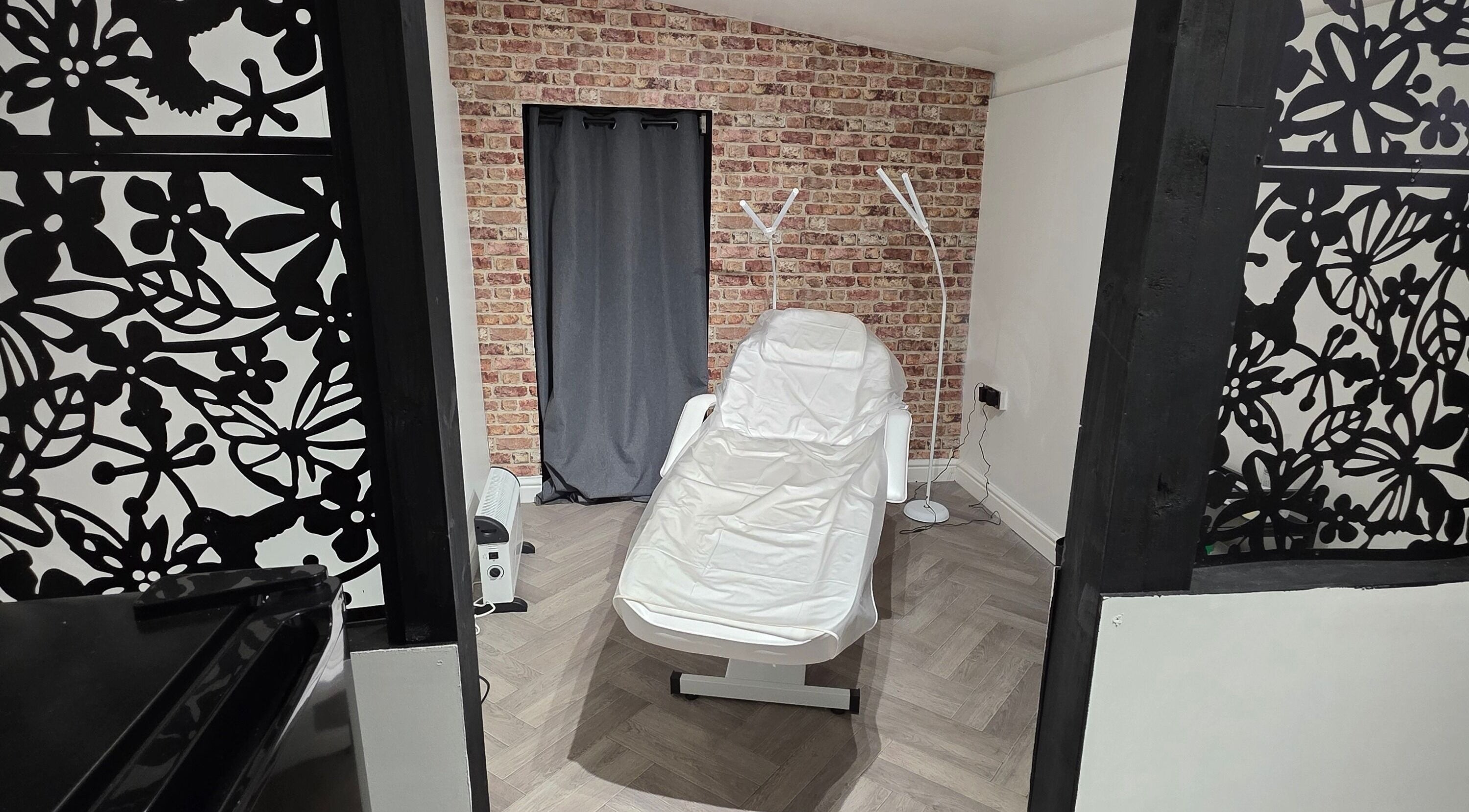 Tranquil treatment room at Flawless in Wigan, England with a comfortable chair and stylish décor.