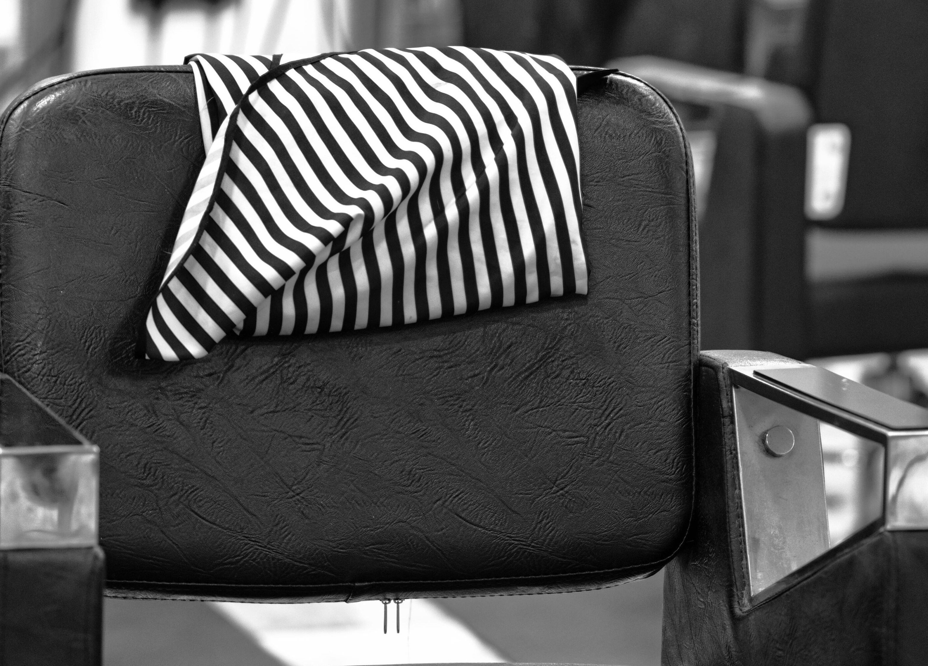 Barber chair with striped cloth at Flawless, Wigan, England, GB. Classic salon style.