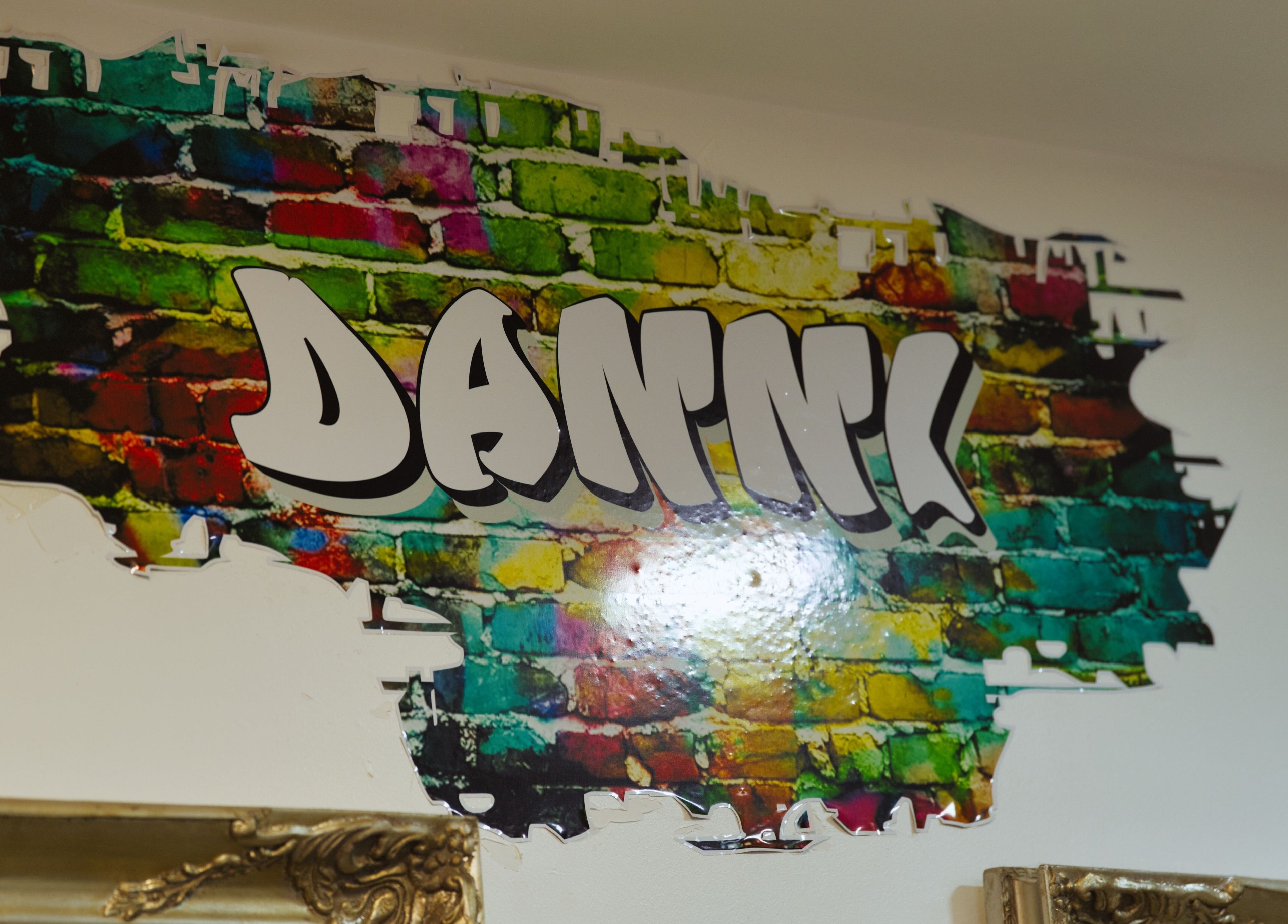 Artistic mural at Flawless, Wigan, England, GB, showcasing the vibrant name 'Danni' in graffiti style.
