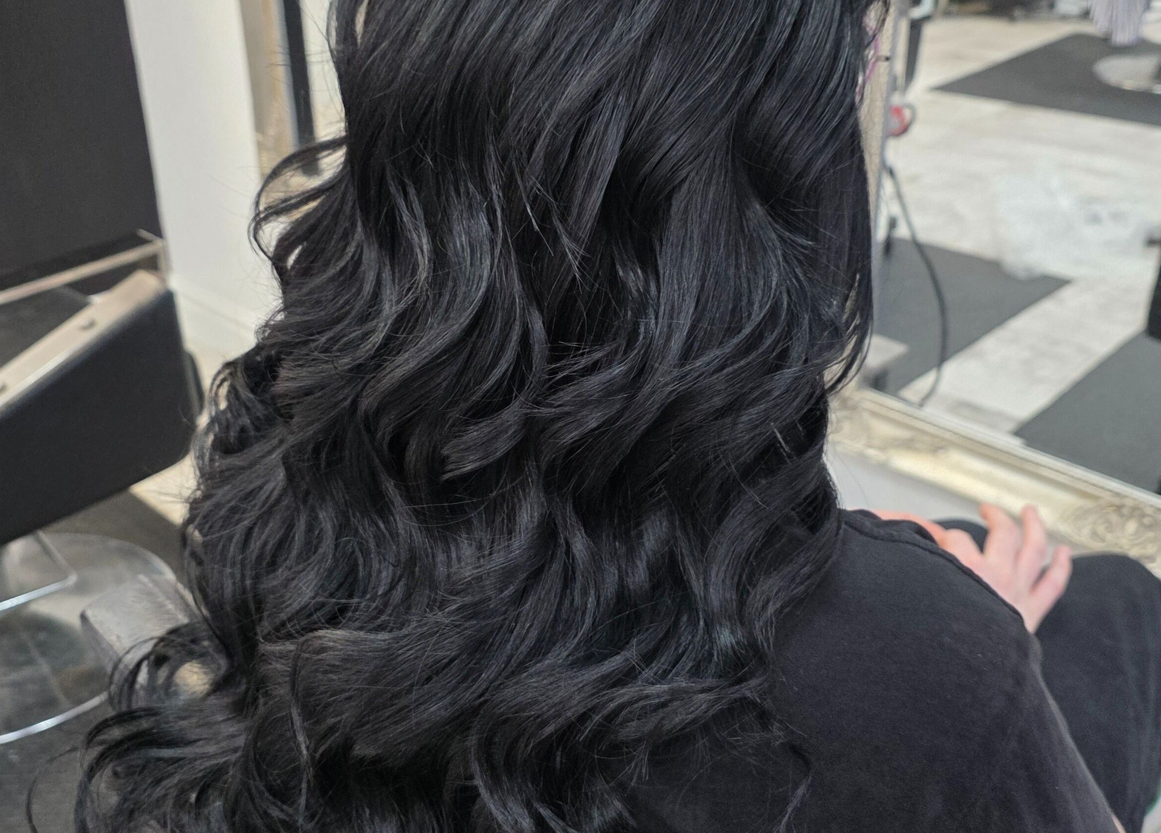Beautiful wavy black hair styled at Flawless (Danni at Flawless), Wigan, England, GB salon mirror reflection.
