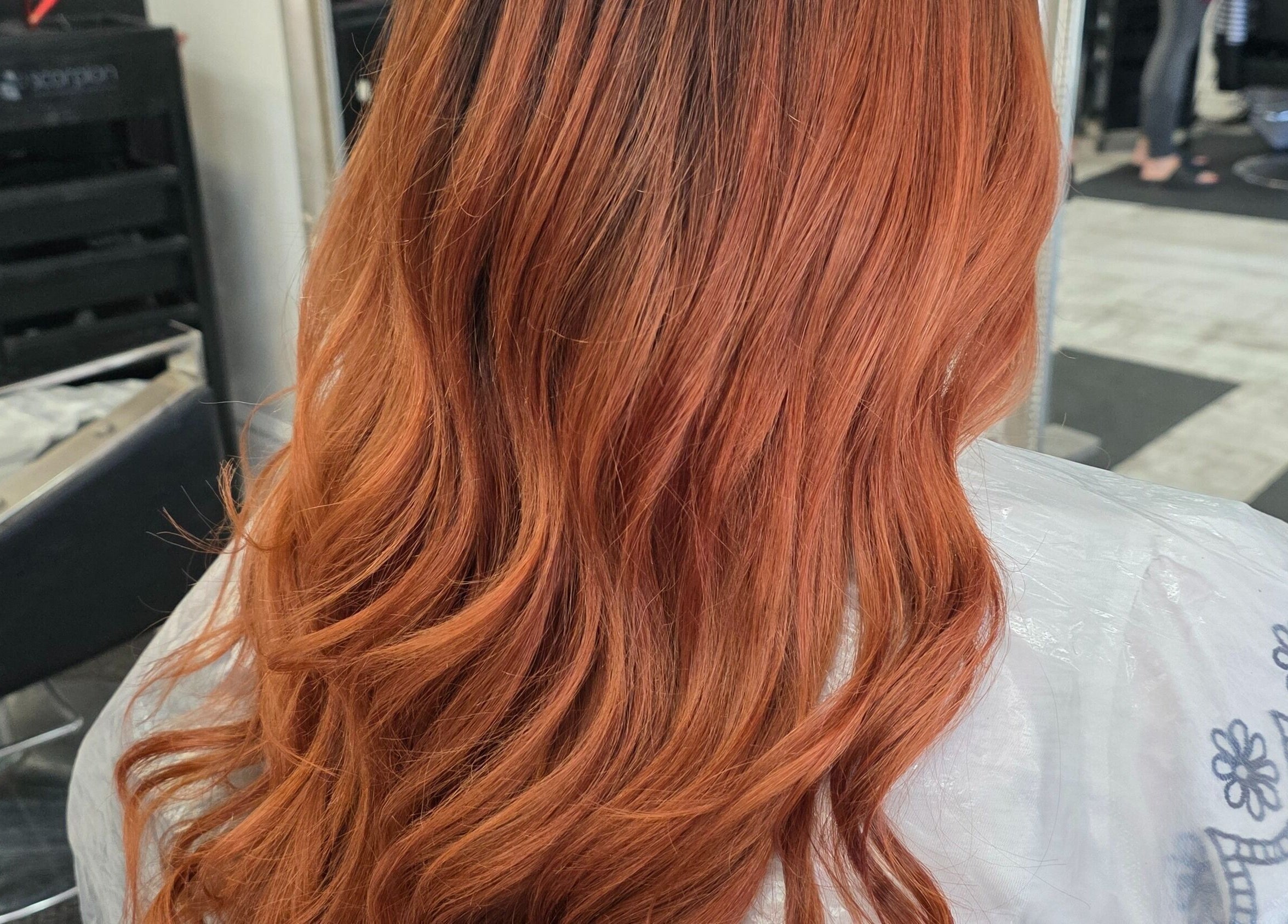 Lustrous ginger hair styled in waves at Flawless (Danni at Flawless) Wigan, England, GB.