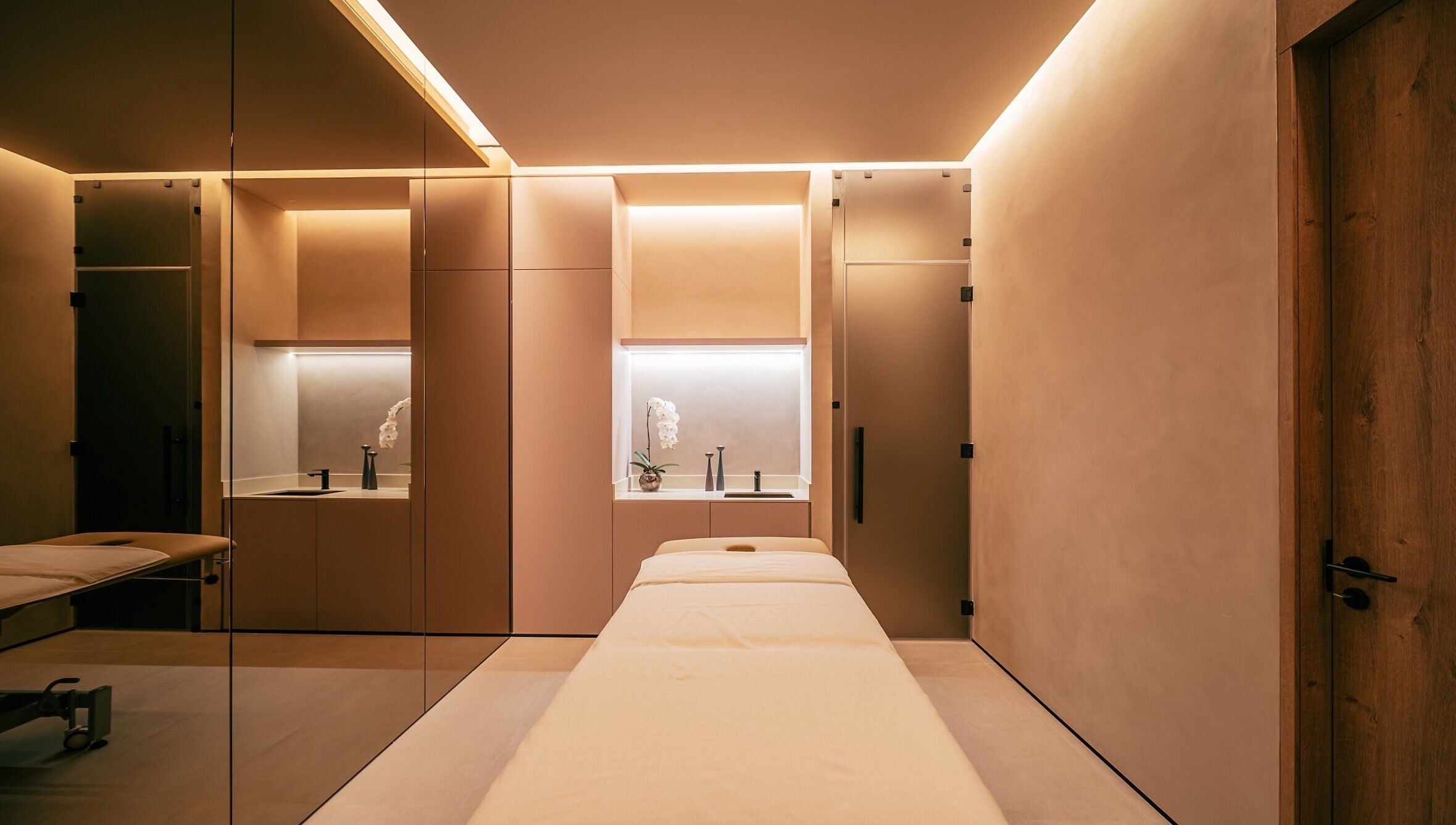 Luxurious spa room at Wellnest, Dubai, AE showcasing a massage table with elegant lighting.
