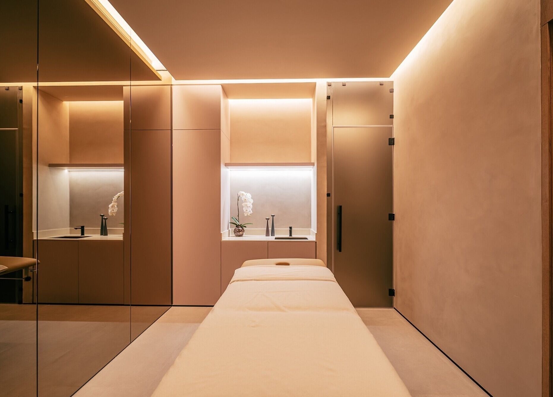 Luxurious spa room at Wellnest, Dubai, AE showcasing a massage table with elegant lighting.