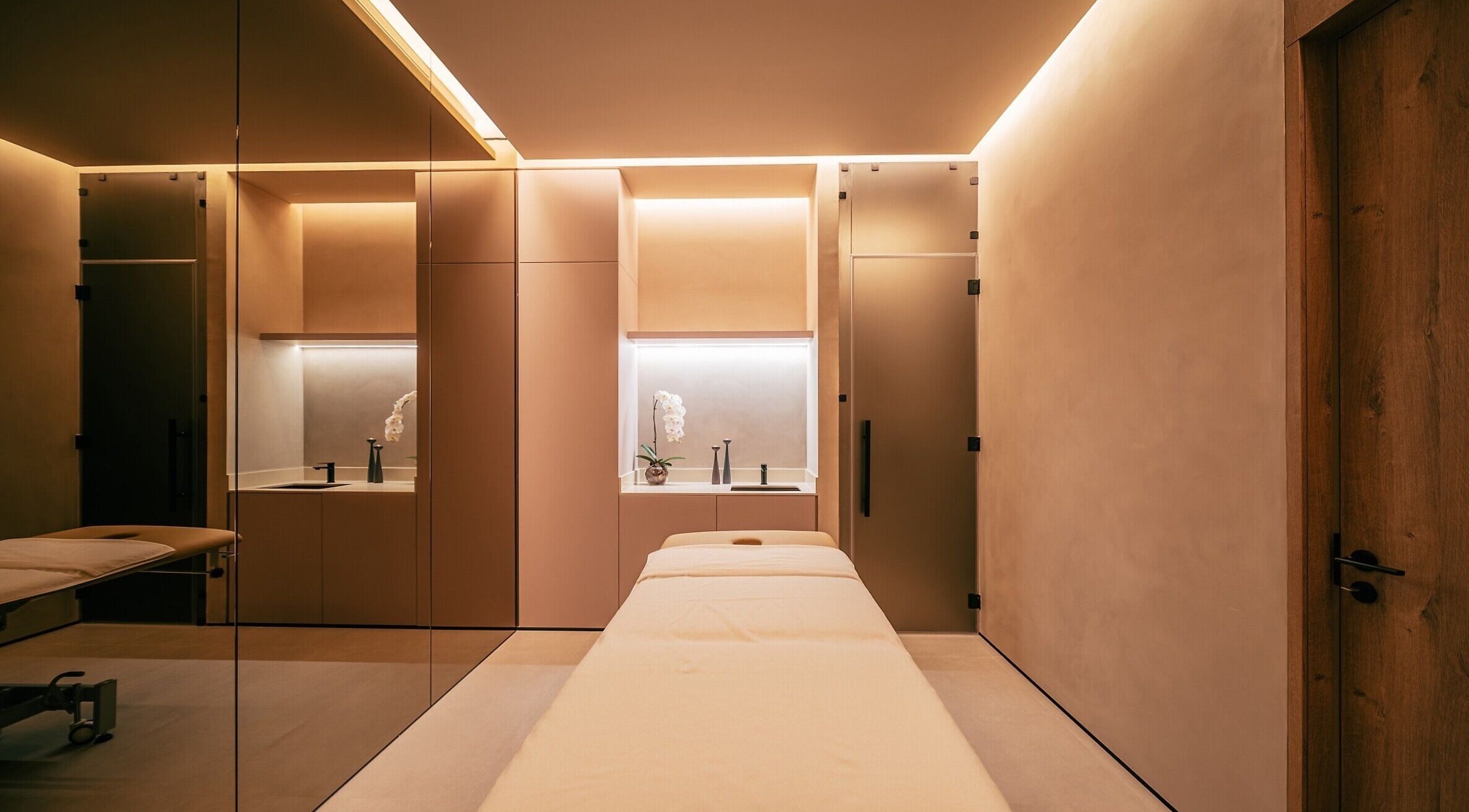Luxurious spa room at Wellnest, Dubai, AE showcasing a massage table with elegant lighting.
