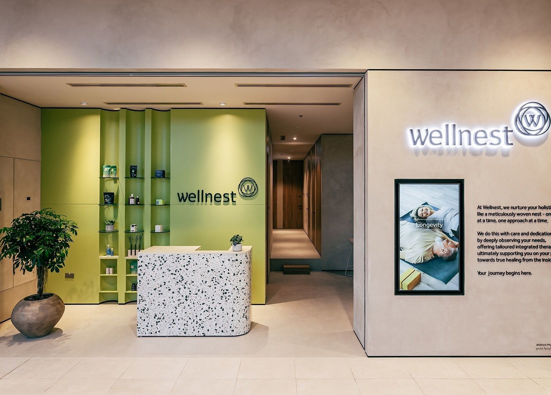 Wellnest reception area in Dubai, AE, showcasing a cozy green interior and serene welcome desk.