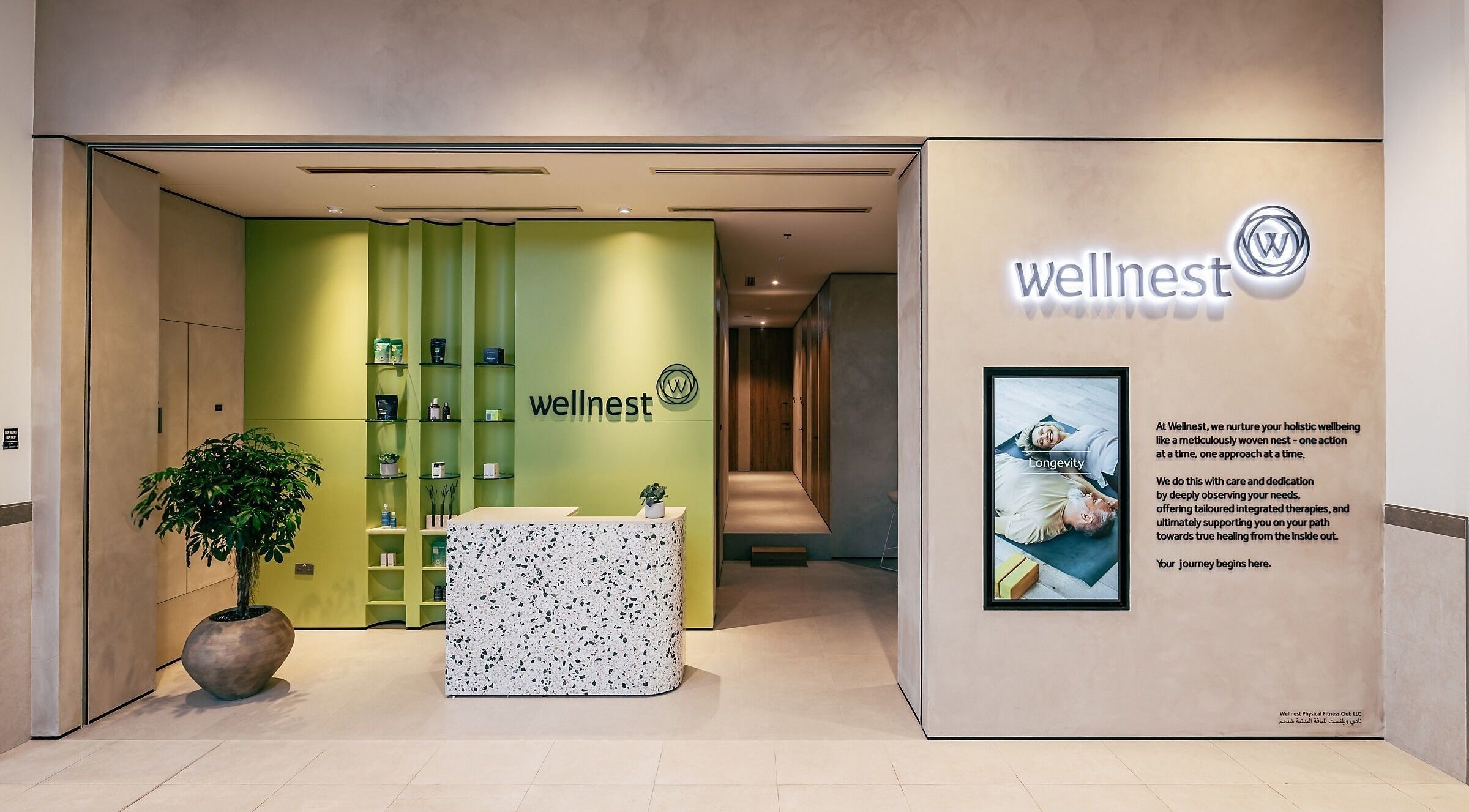 Wellnest reception area in Dubai, AE, showcasing a cozy green interior and serene welcome desk.